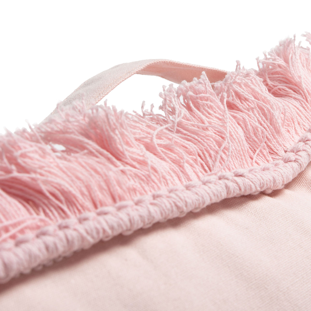 A pink fabric carry loop sits above dense fringe and textured trim on this soft floor cushion. || FLP1018C || handle_studio