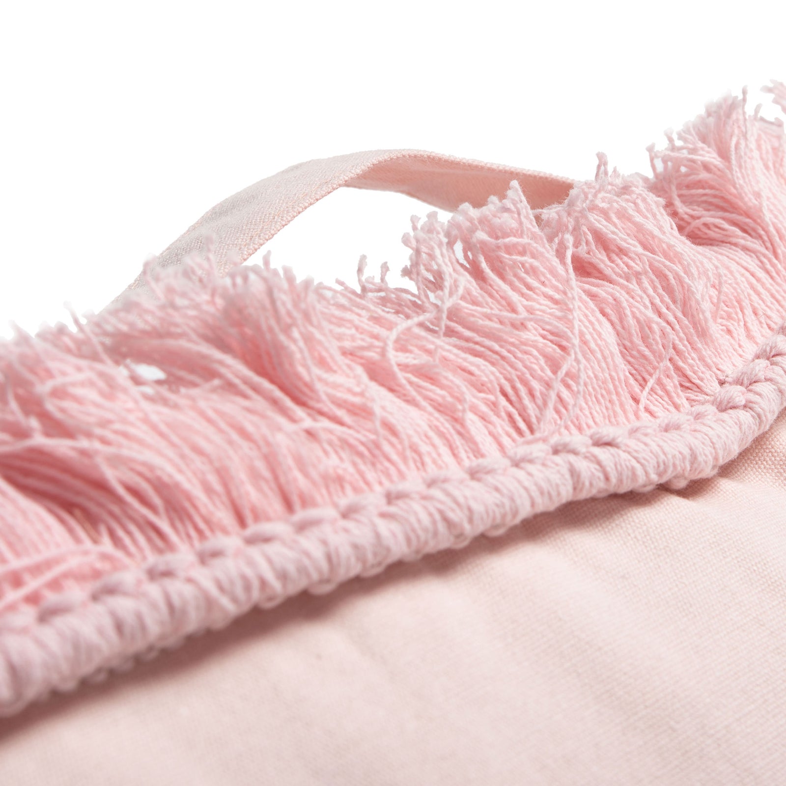A pink fabric carry loop sits above dense fringe and textured trim on this soft floor cushion. || FLP1018C || handle_studio