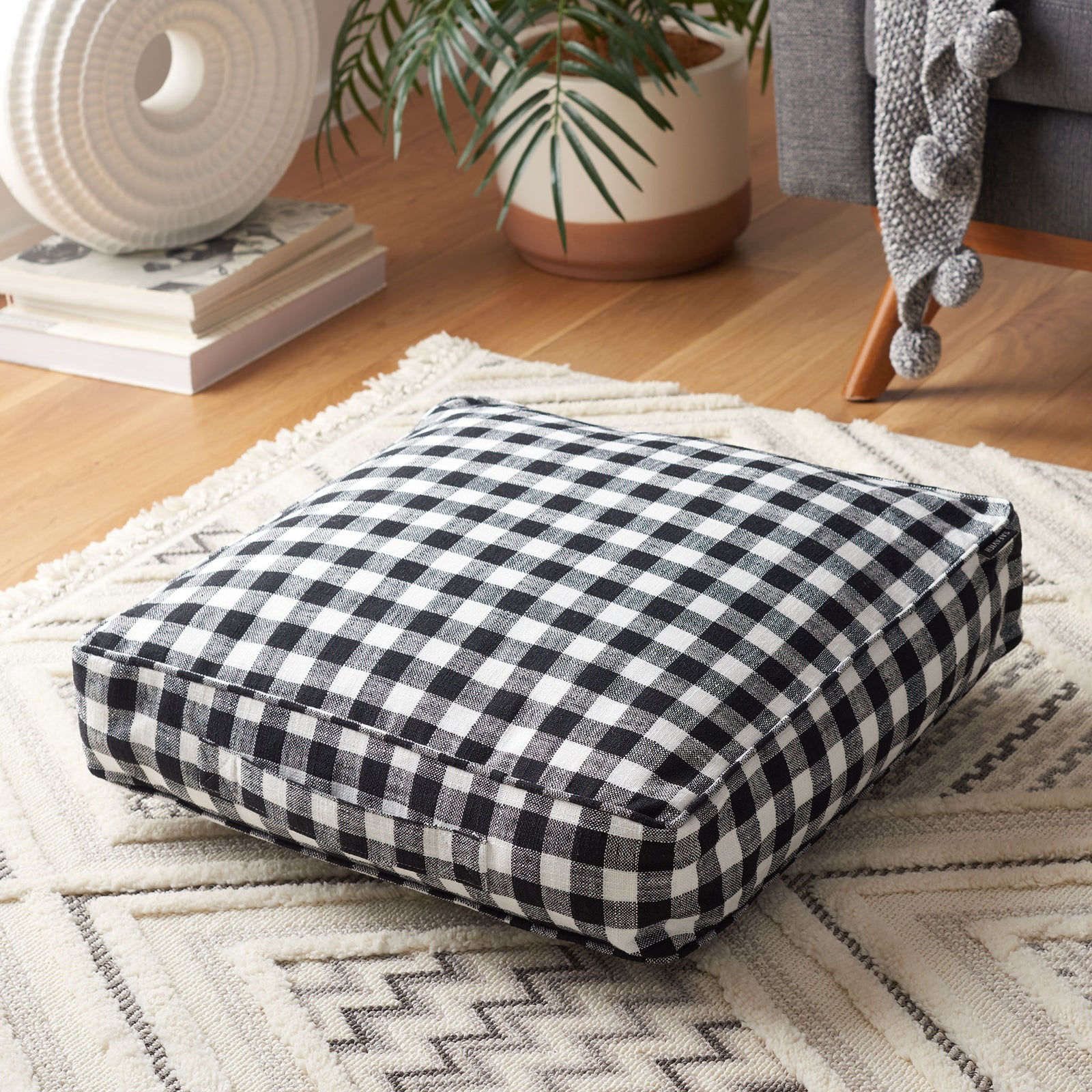 This gingham floor pillow adds cozy comfort and bold contrast to a relaxed living area || FLP1019A || front_angle_room