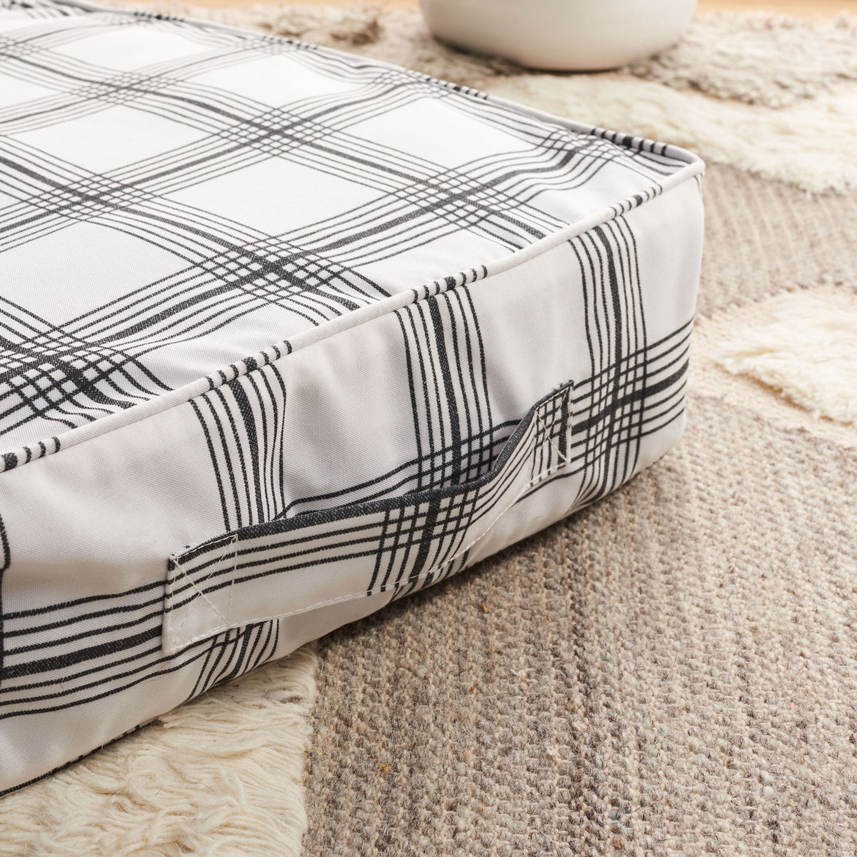 A woven carrying handle blends into the floor pillow's black-and-white plaid || FLP1020A || handle_room