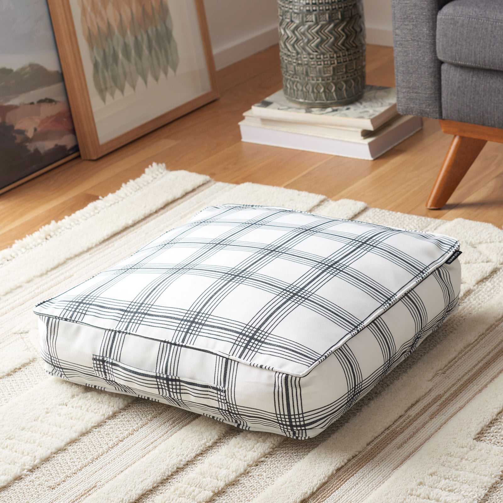 Dark pinstripes intersect across a soft white floor pillow for a fresh, versatile accent || FLP1020A || front_angle_room