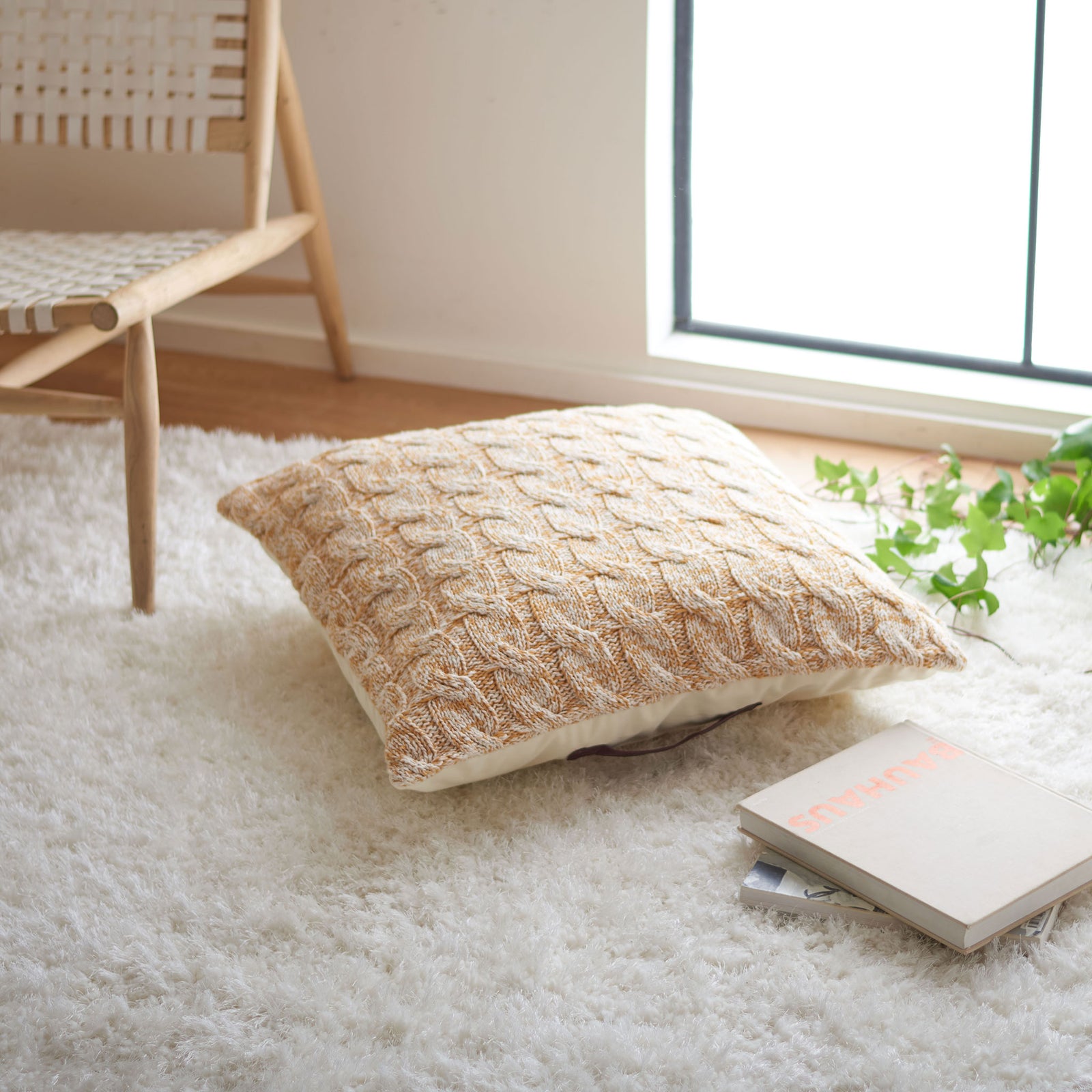 A plush mustard and cream floor pillow adds cozy texture and extra seating to a bright living space || FLP3000A || front_angle_room