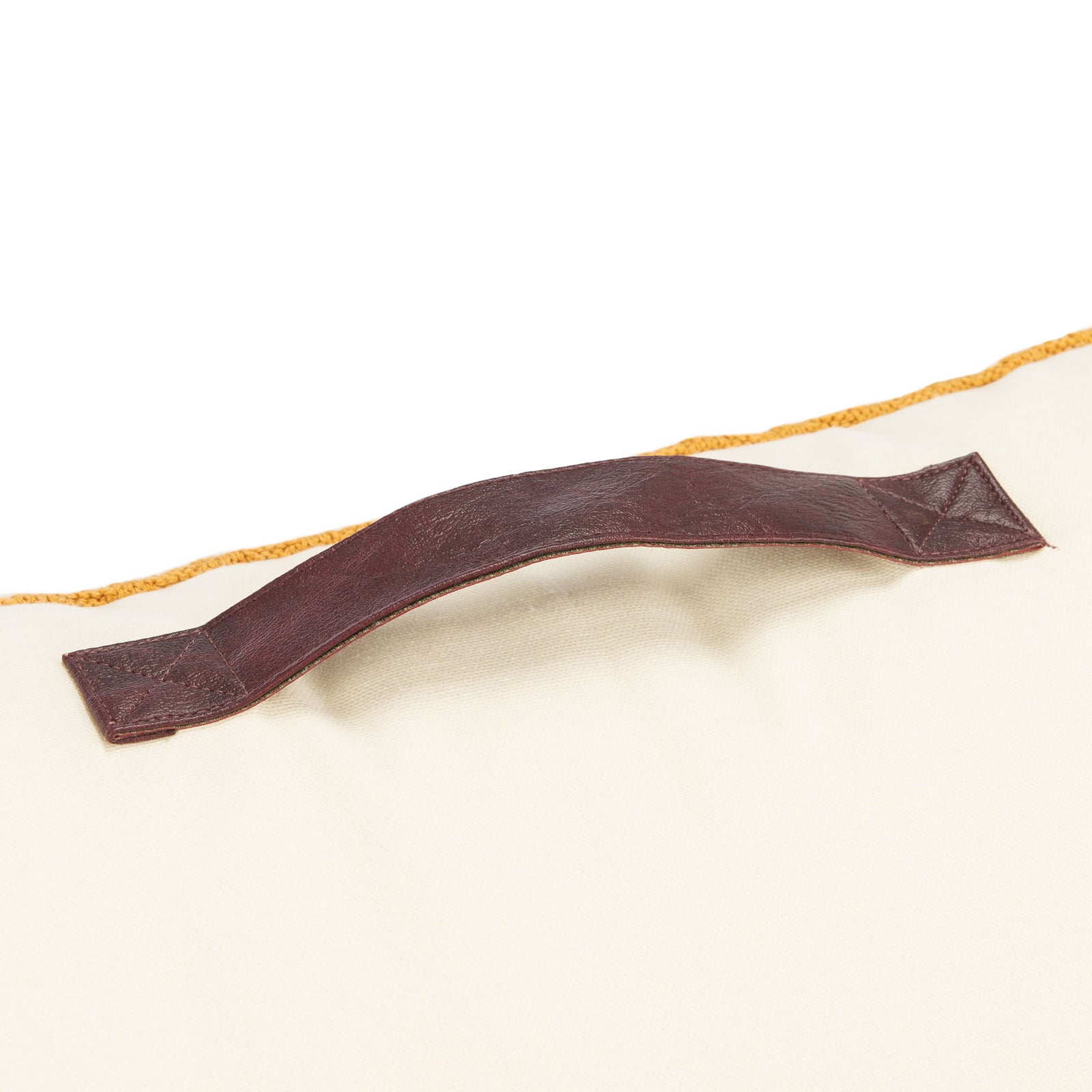 Dark brown carry handle sewn to a beige pillow with mustard edging || FLP3005A || handle_studio