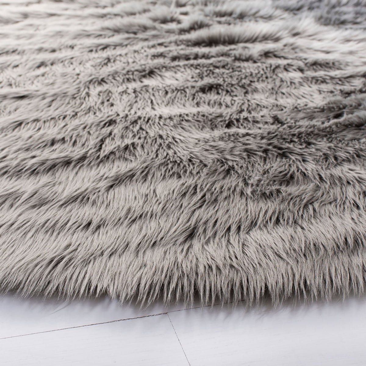 Long, wavy gray shag fibers and a fluffy edge bring luxurious texture underfoot