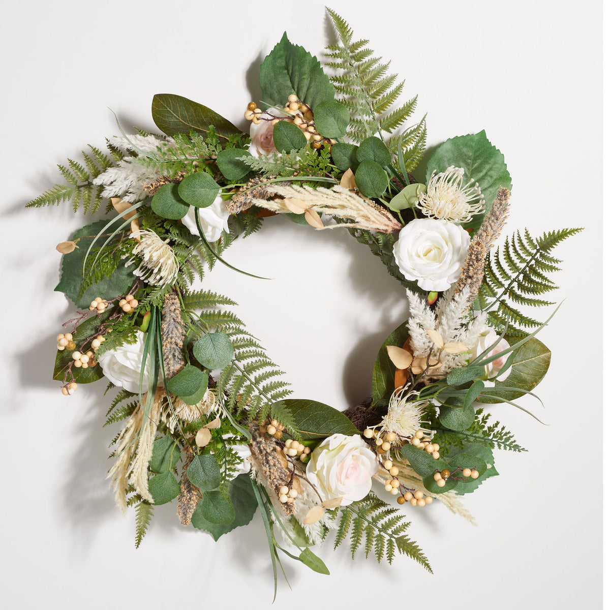 Ivory roses and textured greenery surround an open wreath center. || FXP1023A || front_studio