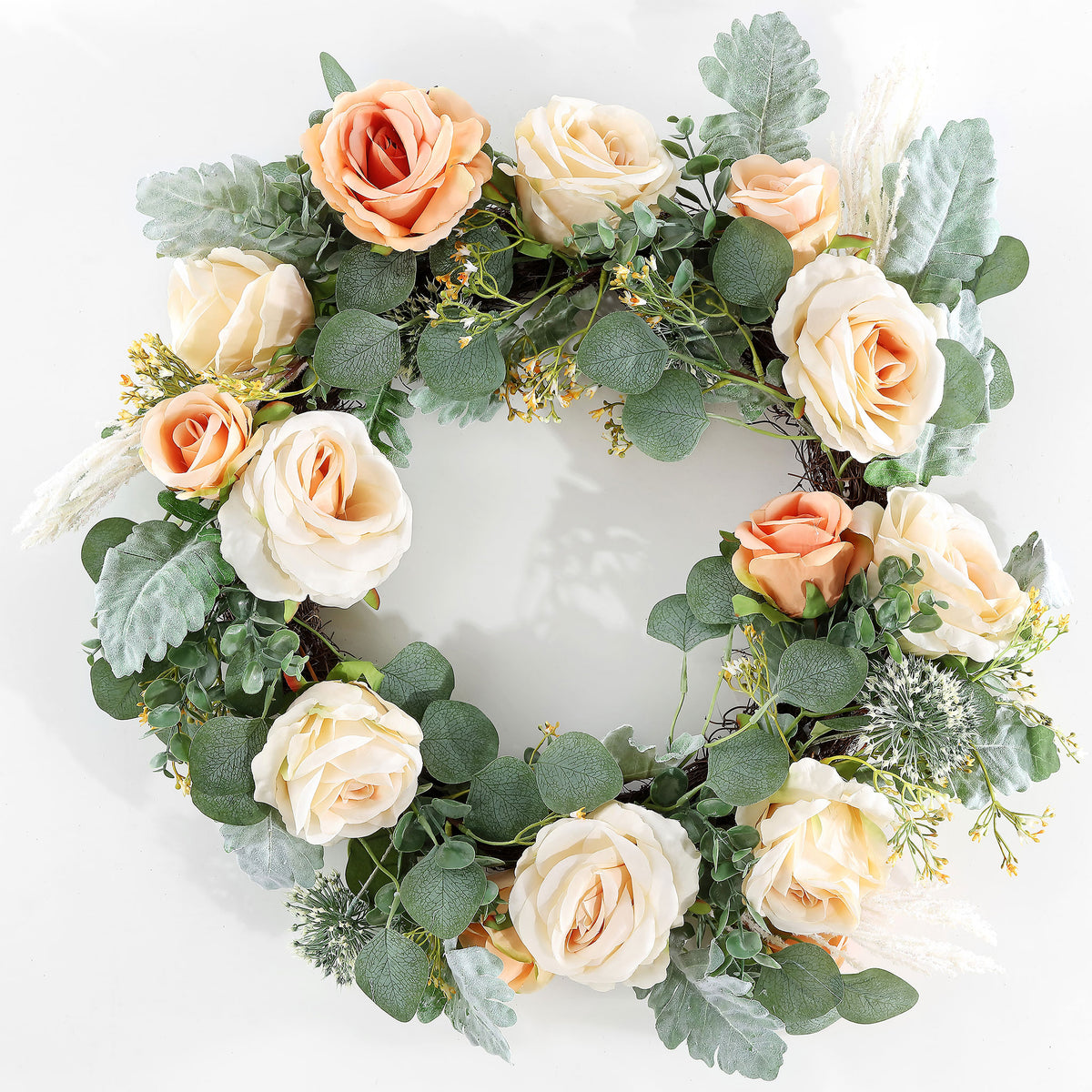 Peach and cream roses brighten a ring of silvery green foliage. || FXP1024A || front_studio