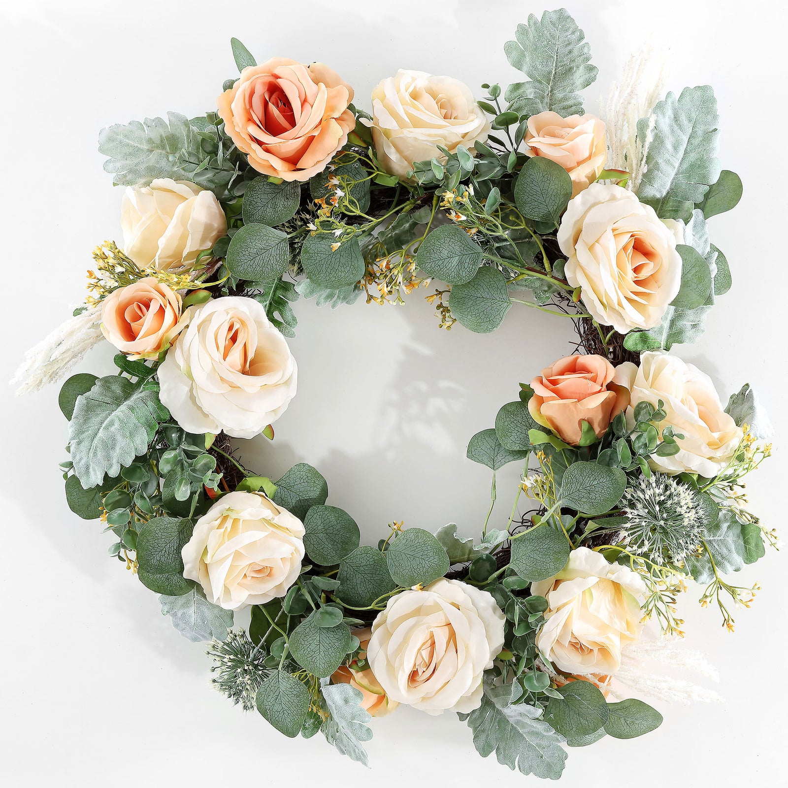 Peach and cream roses brighten a ring of silvery green foliage. || FXP1024A || front_studio