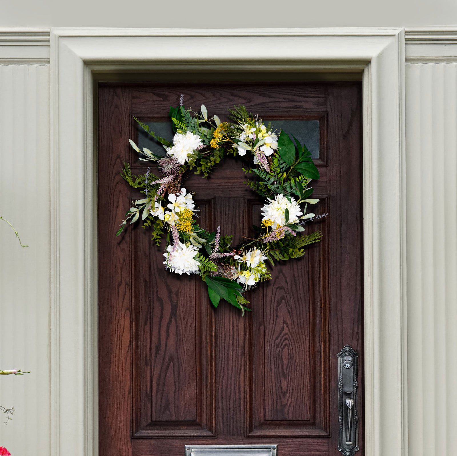 White dahlia blooms and greenery brighten a dark wood door. || FXP1028A || front_room