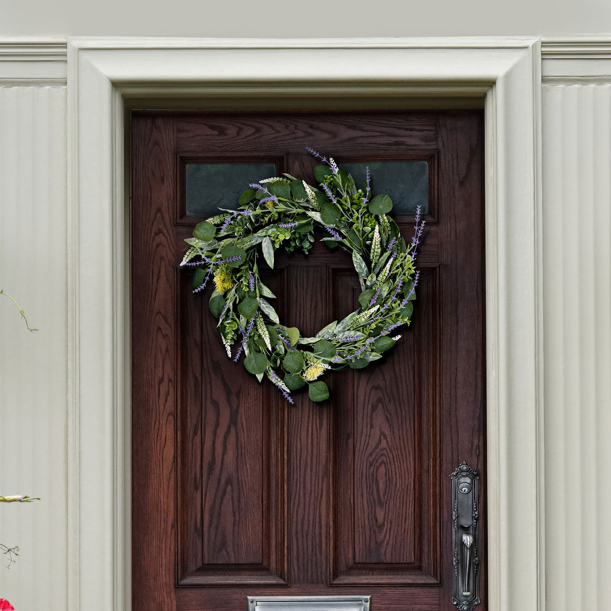 Silver-green eucalyptus and purple sprigs create a fresh door accent.