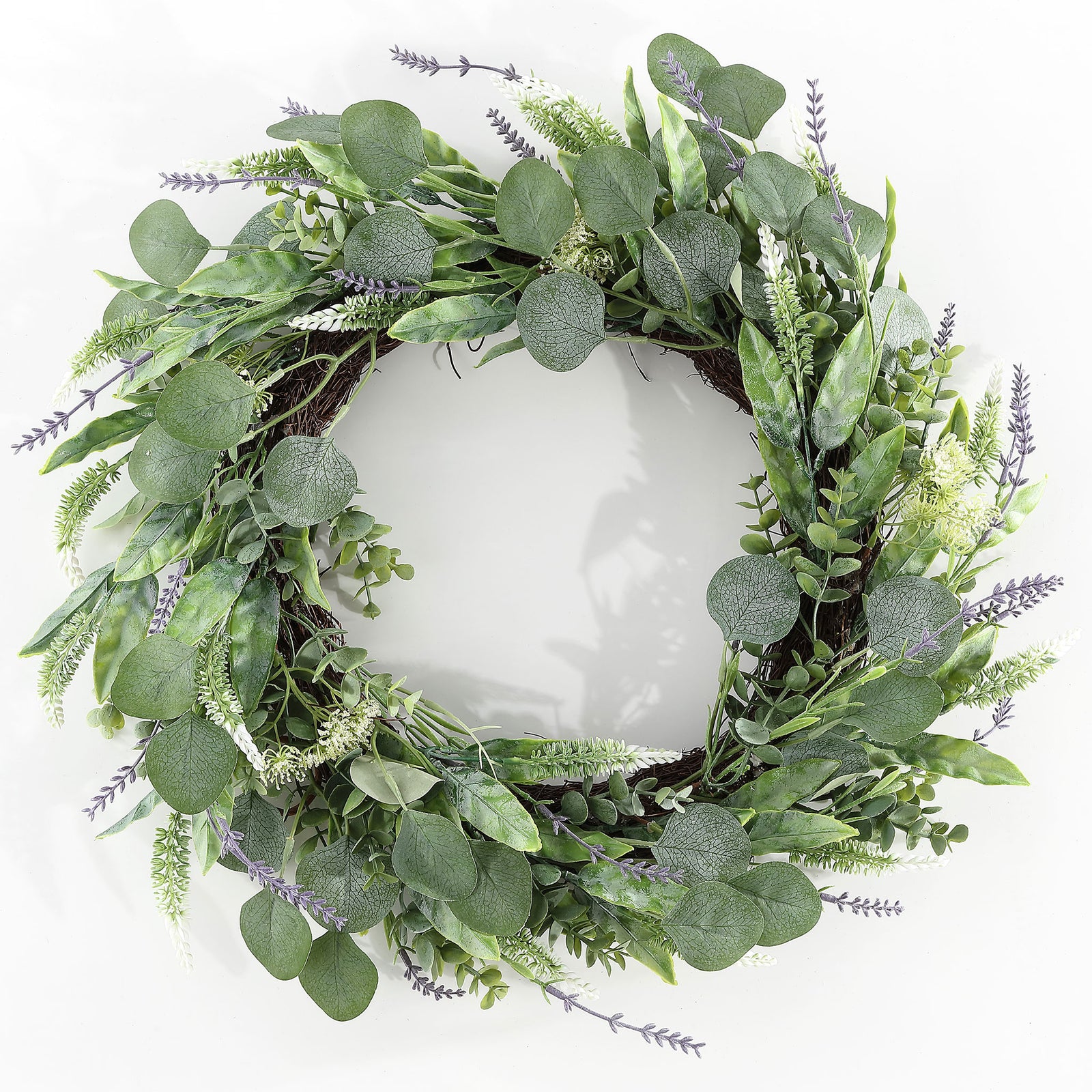 Green eucalyptus leaves and slender purple sprigs fill an airy wreath. || FXP1029A || front_studio