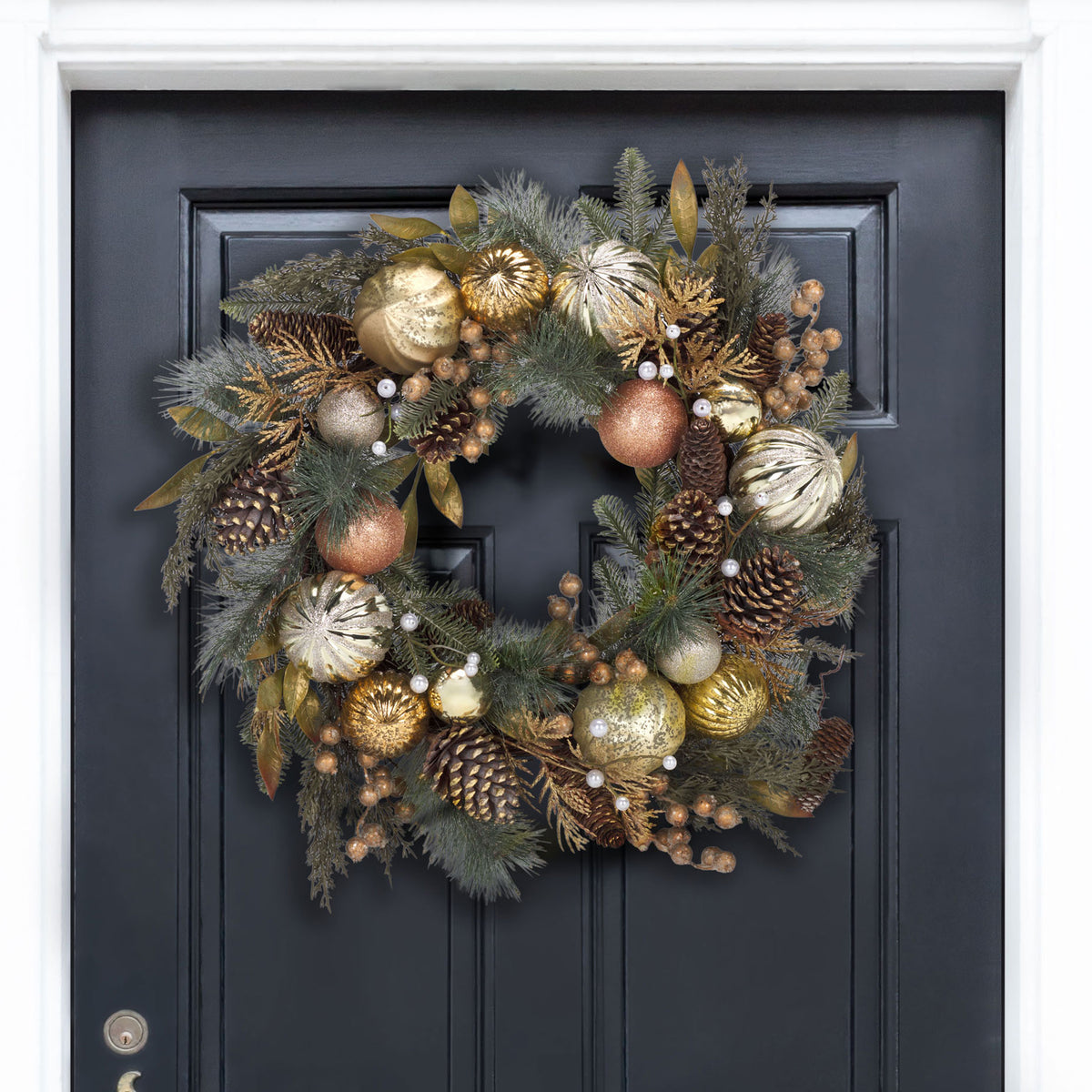 Gold ornaments and evergreen sprigs bring festive sparkle to a dark door. || FXP1033A || front_room