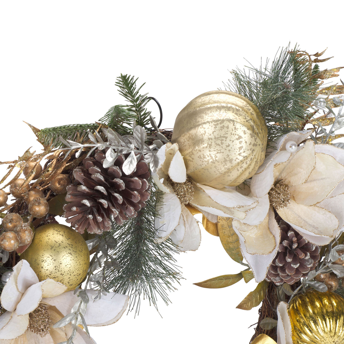 A white poinsettia blooms beside gold baubles and natural pine cones.