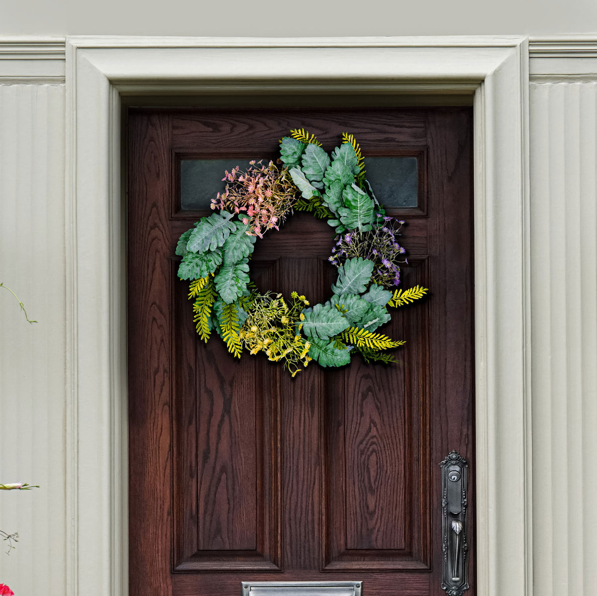 Silvery leaves and delicate spring flowers soften a dark entry door. || FXP1036A || front_room
