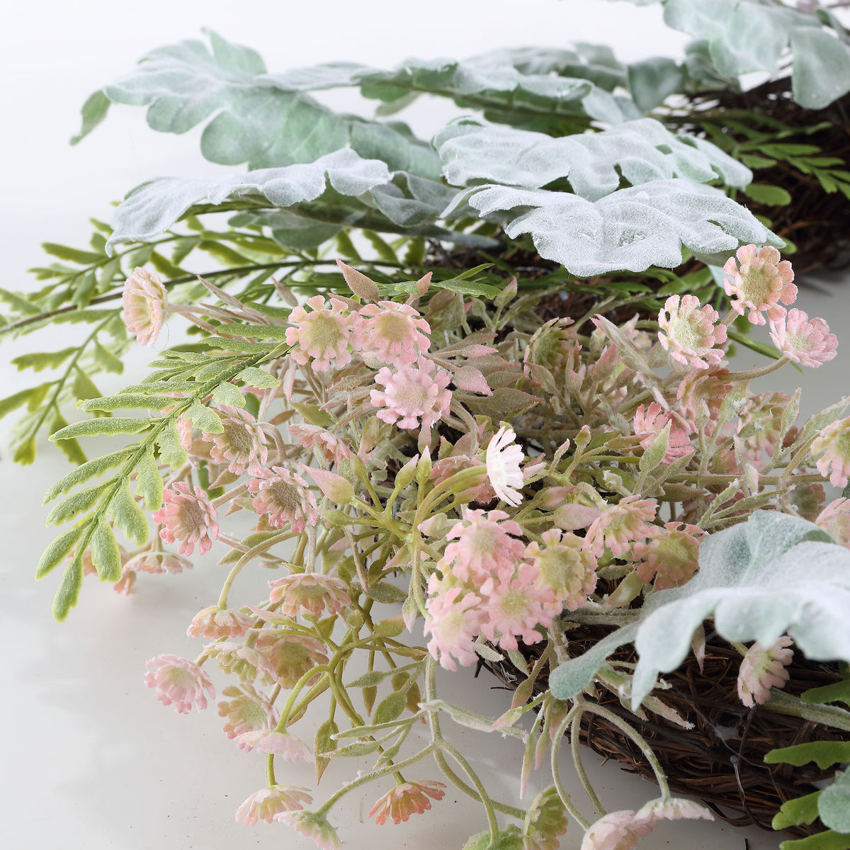 Small blush blossoms peek through frosted-looking leaves and wispy stems. || FXP1036A || detail_studio