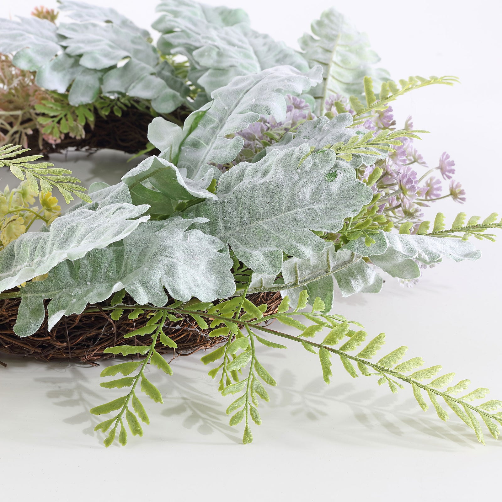 Dusty miller foliage layers soft silver-green color over fine greenery. || FXP1036A || detail_studio