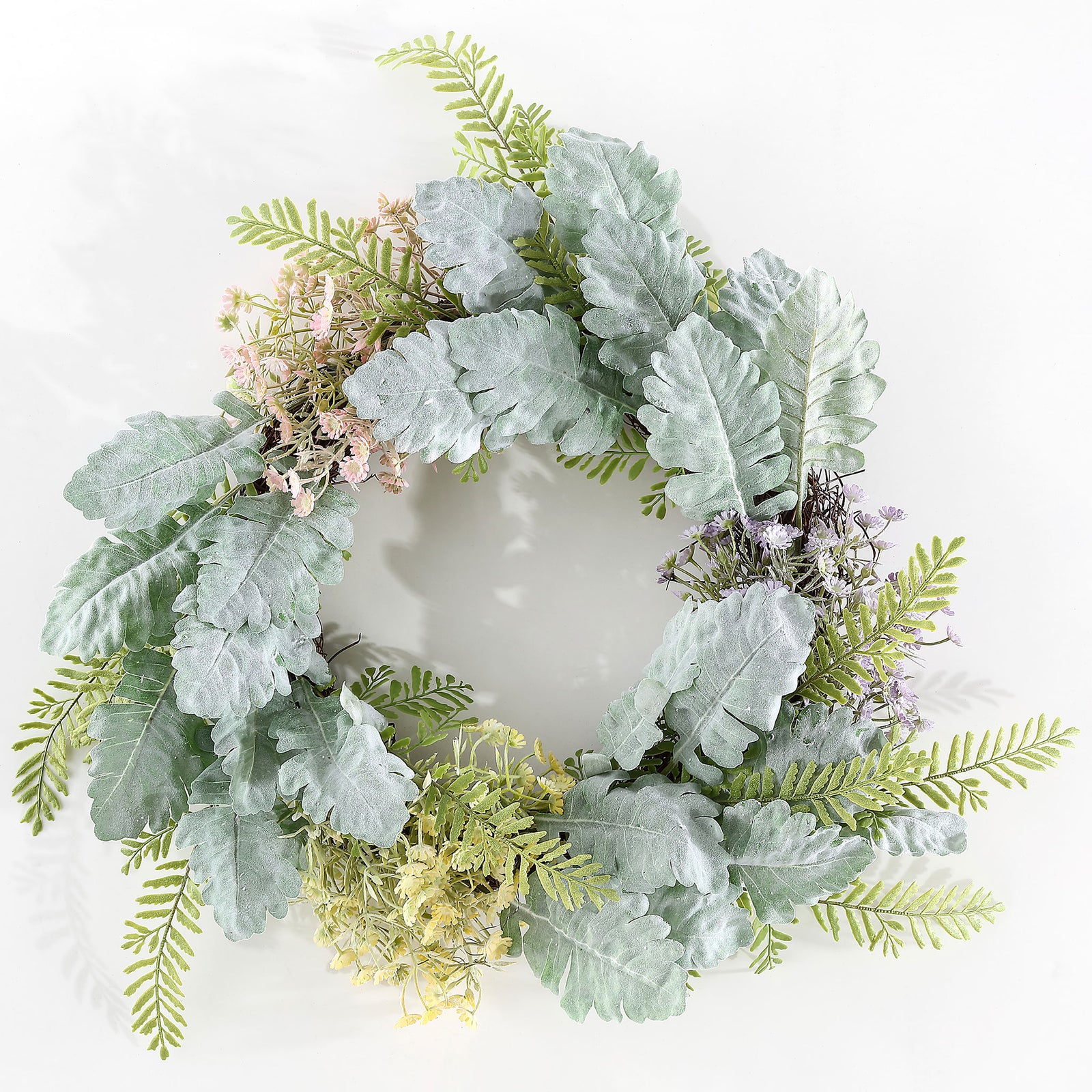 Silver-green leaves and pastel blooms form a light spring wreath. || FXP1036A || front_studio