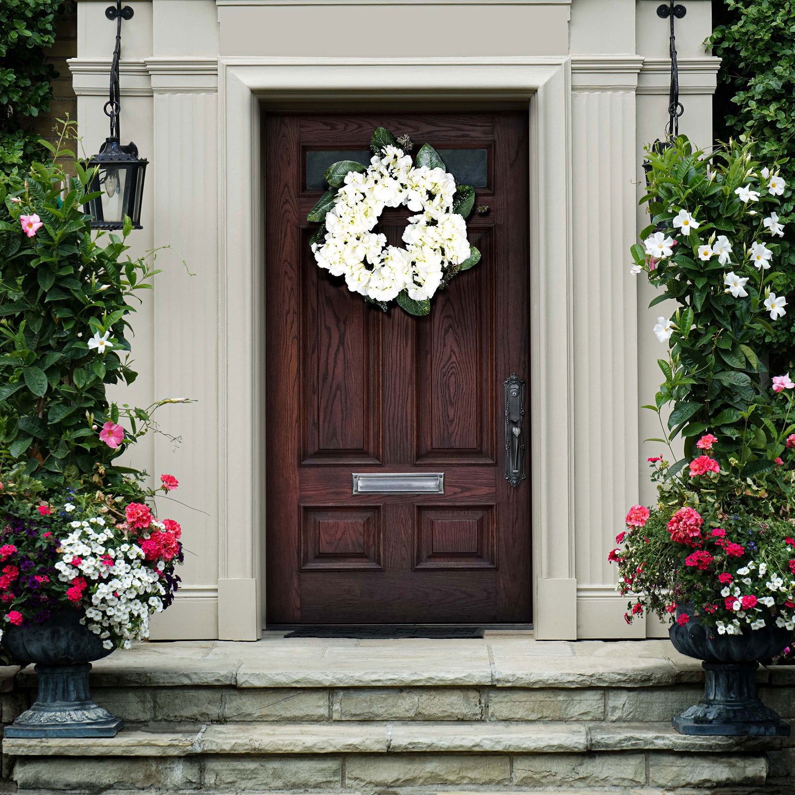 A white hydrangea wreath lends fresh contrast to a wood entry door. || FXP1037A || front_room