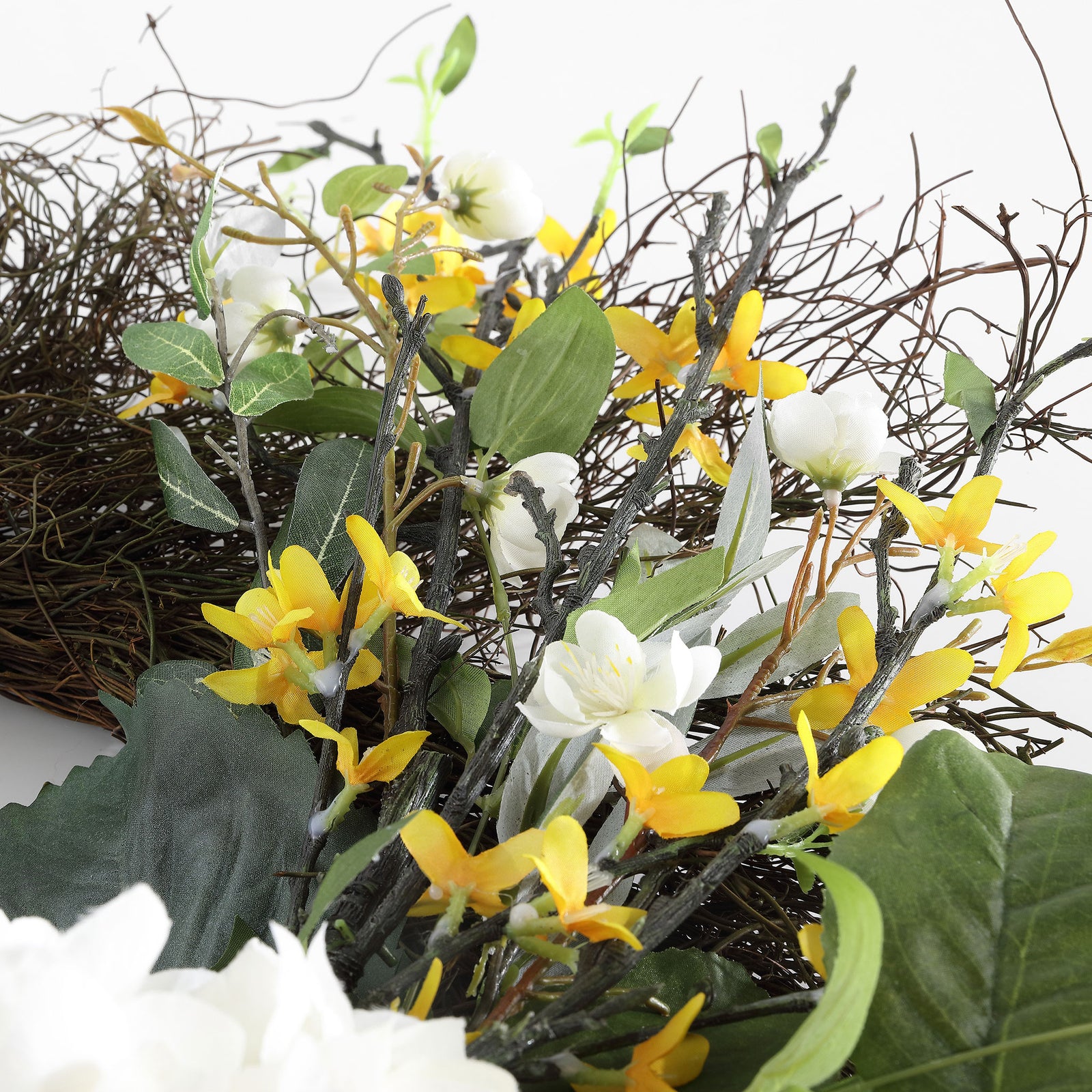 Small yellow blossoms weave through leafy stems and rustic twigs. || FXP1039A || detail_studio