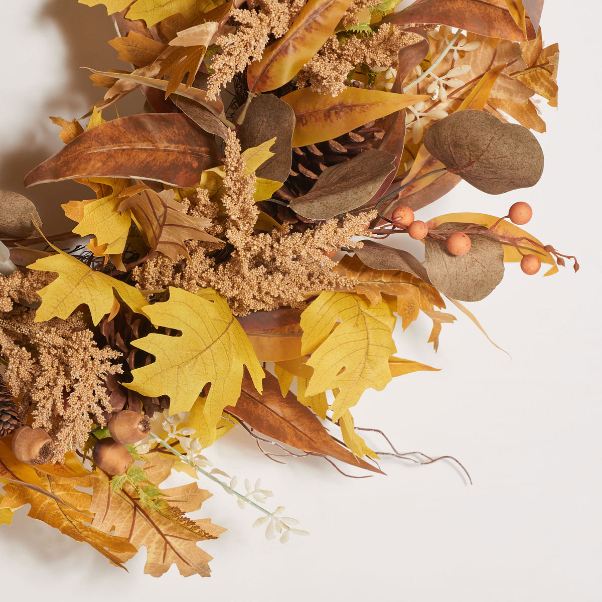Yellow leaves mingle with eucalyptus, pale berries, and feathery sprigs. || FXP1042A || detail_studio