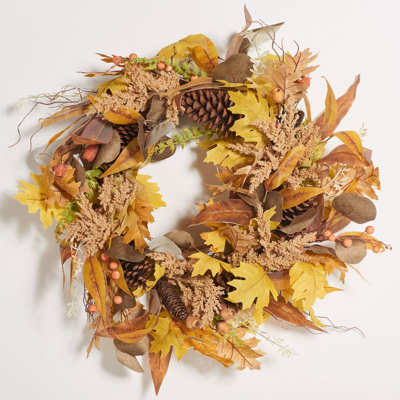 Dusty gold leaves, pine cones, and berries create an abundant fall wreath. || FXP1042A || front_studio