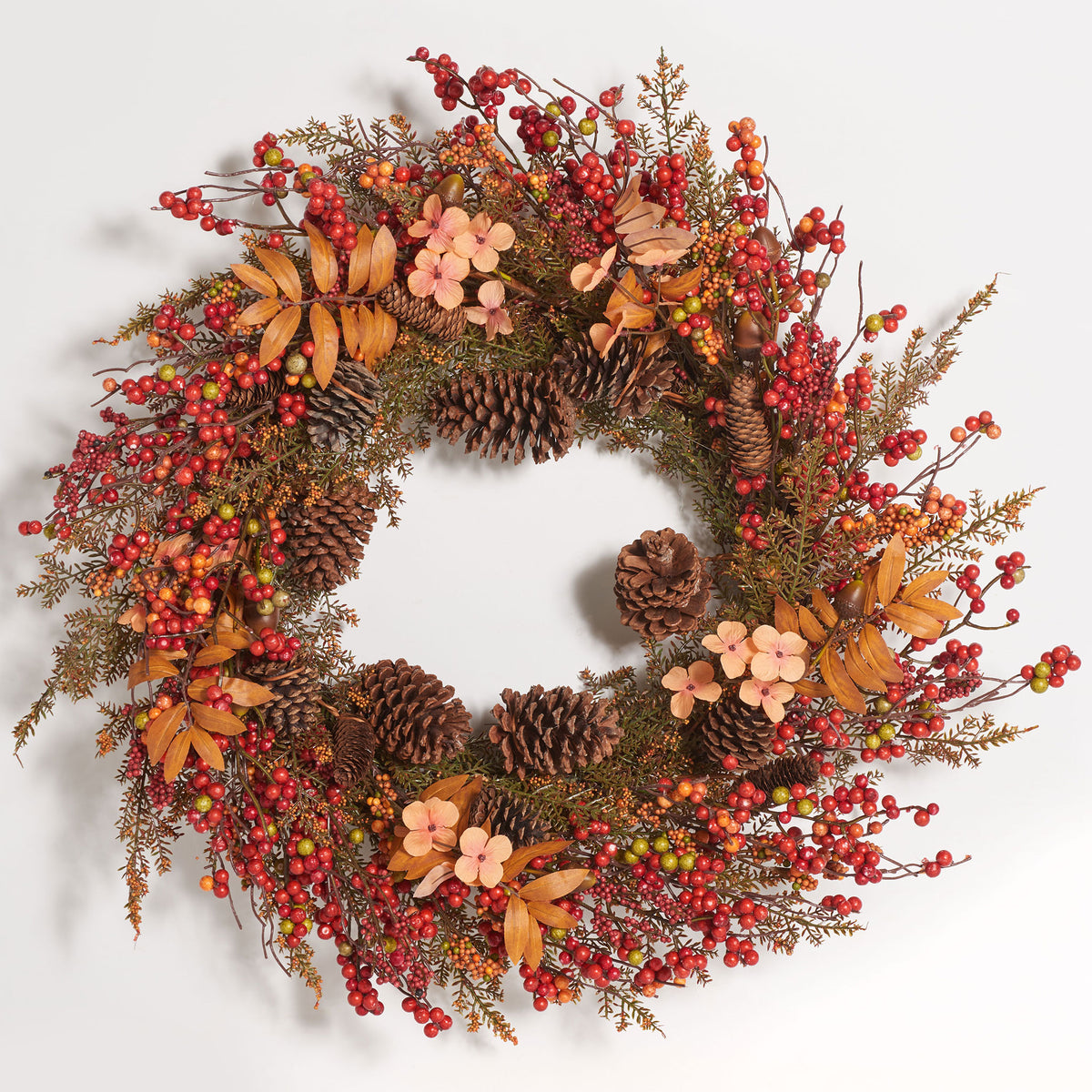 Clusters of vibrant berries brighten this pine cone and floral fall wreath. || FXP1050A || front_studio