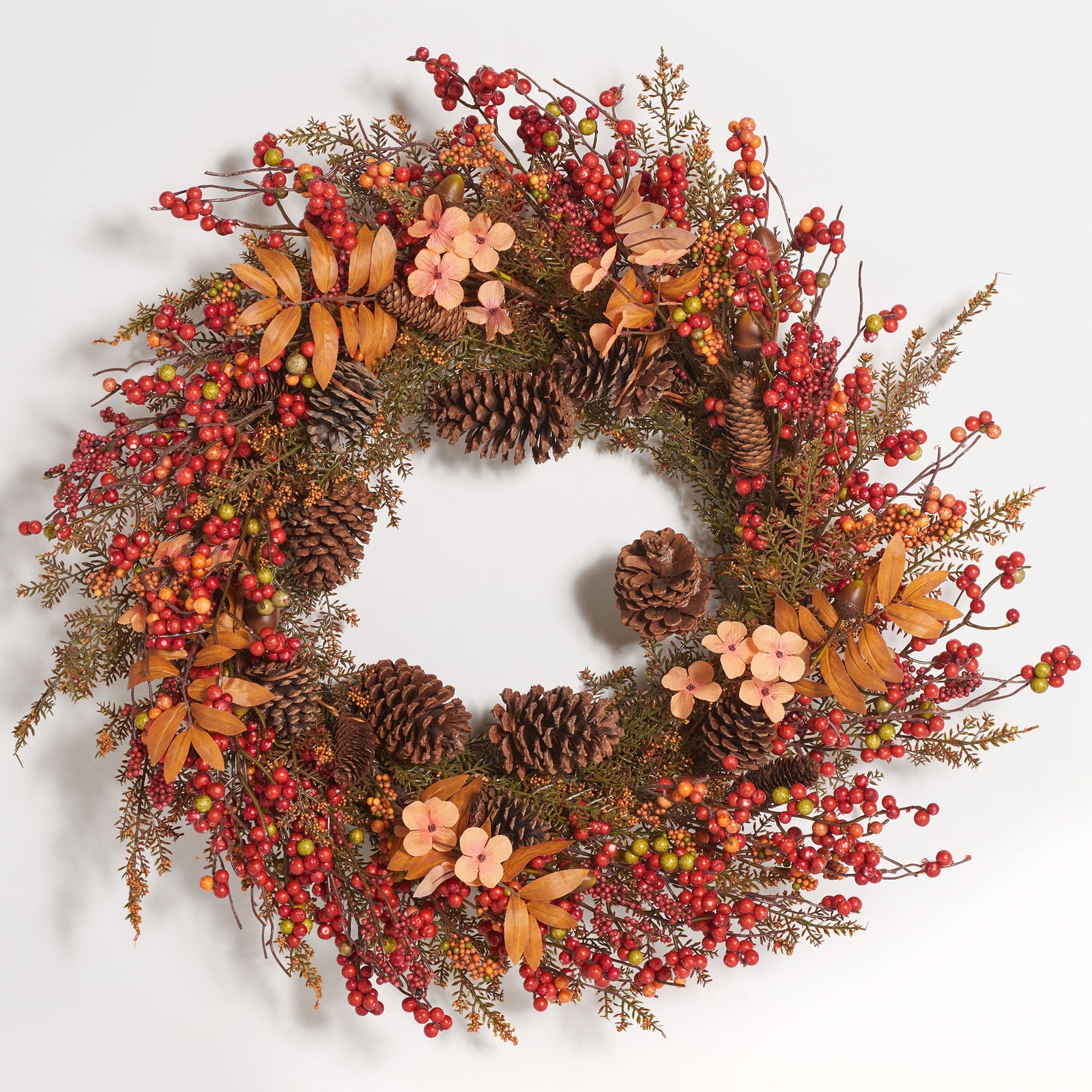 Clusters of vibrant berries brighten this pine cone and floral fall wreath. || FXP1050A || front_studio