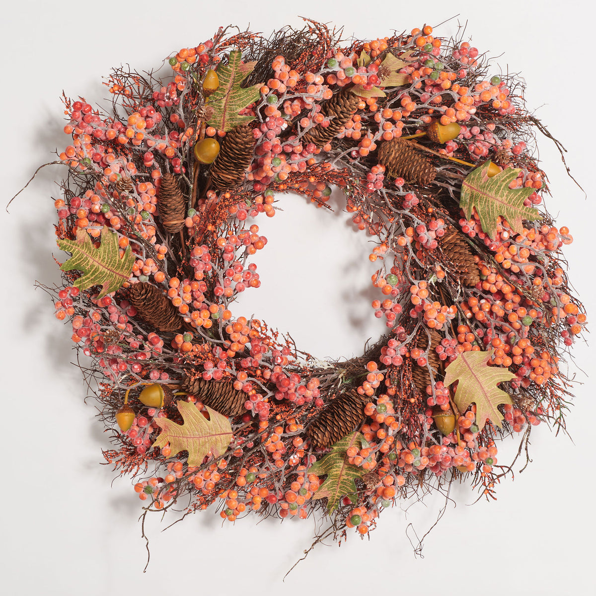 Autumn leaves, pine cones, and colorful berries form a lush harvest wreath. || FXP1054A || front_studio