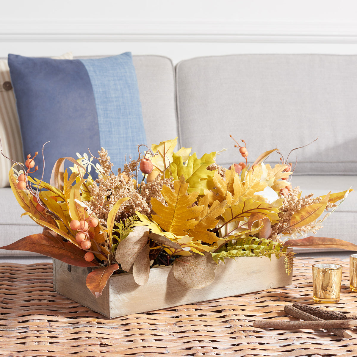 A leafy autumn centerpiece brings harvest color to a coffee table. || FXP1063A || front_angle_room