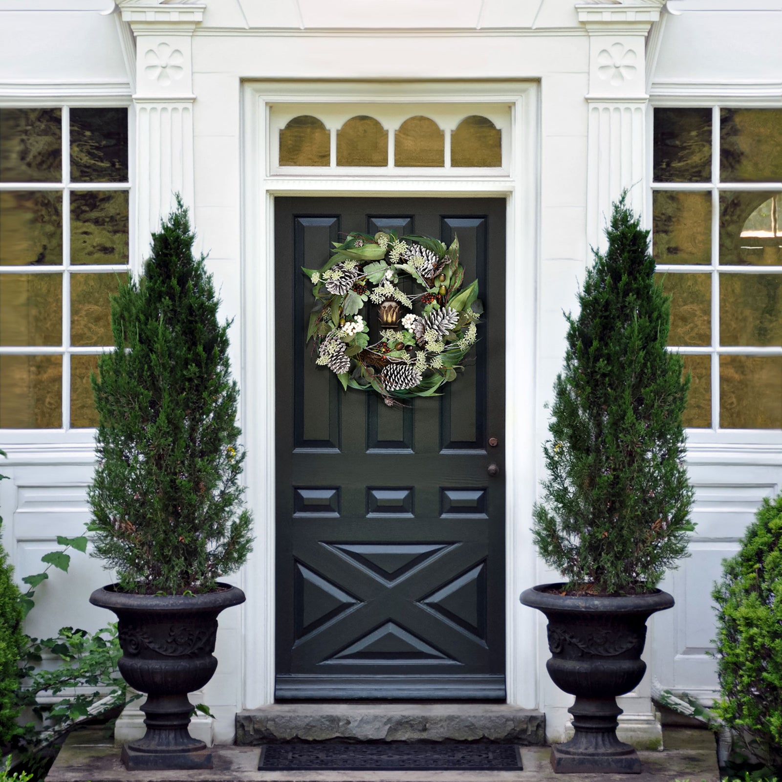 A leafy winter wreath adds a natural holiday accent to the entryway. || FXP1072A || front_room