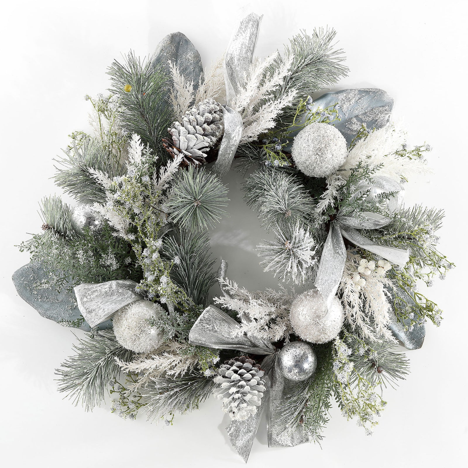 Snow-dusted pine and silver decorations create a bright holiday wreath. || FXP1077A || front_studio