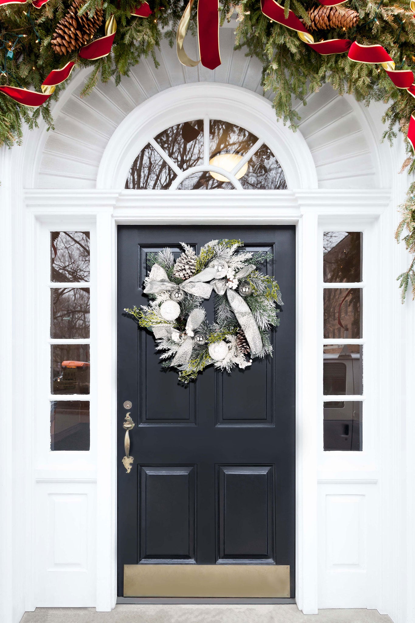 A silver and green wreath adds wintry sparkle to the entryway. || FXP1077A || front_room