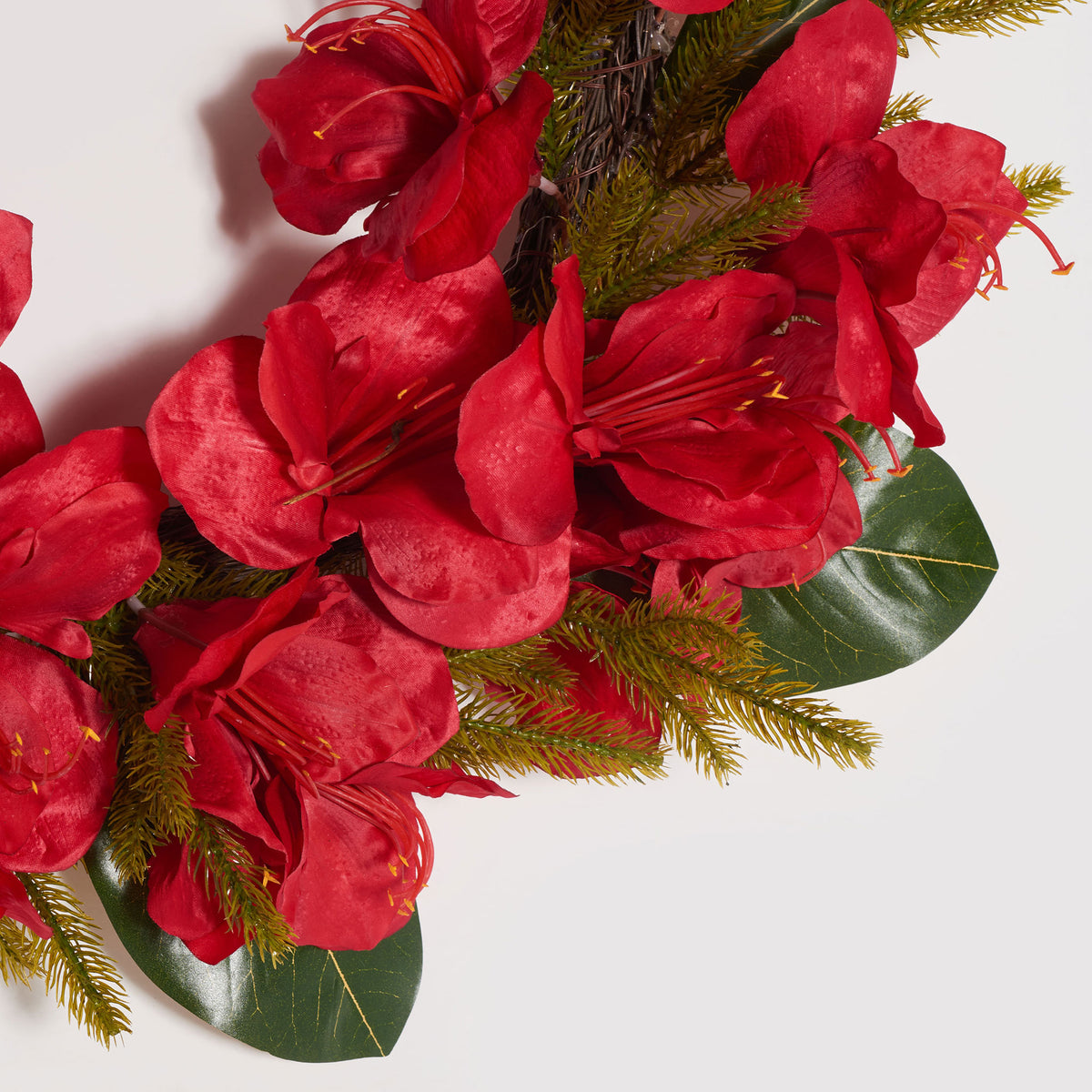 Velvety red petals mingle with glossy leaves and fine evergreen sprigs. || FXP1091A || detail_studio