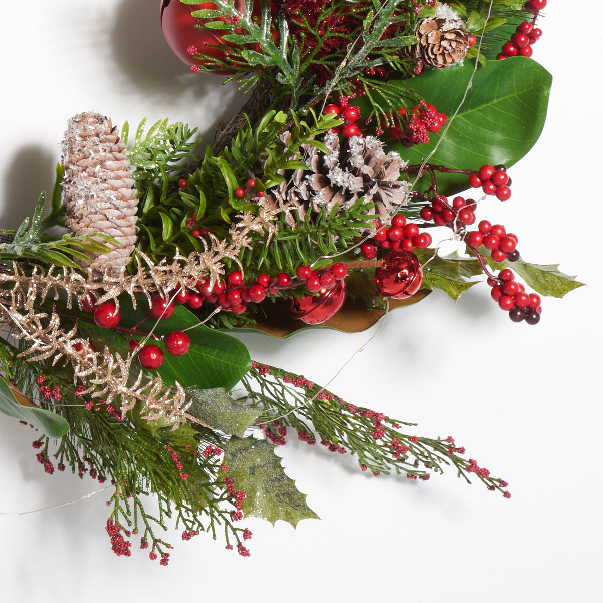 Glossy red bells and berries nestle among pine cones and green foliage. || FXP1092A || detail_studio