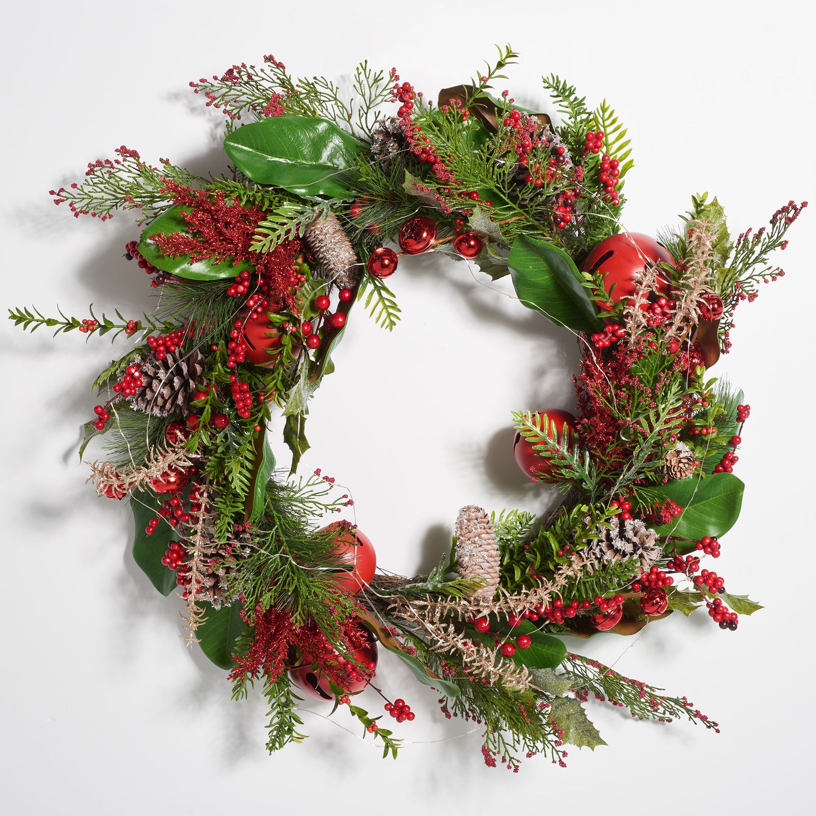 Greenery, red bells, and bright berries give this wreath classic holiday color. || FXP1092A || front_studio