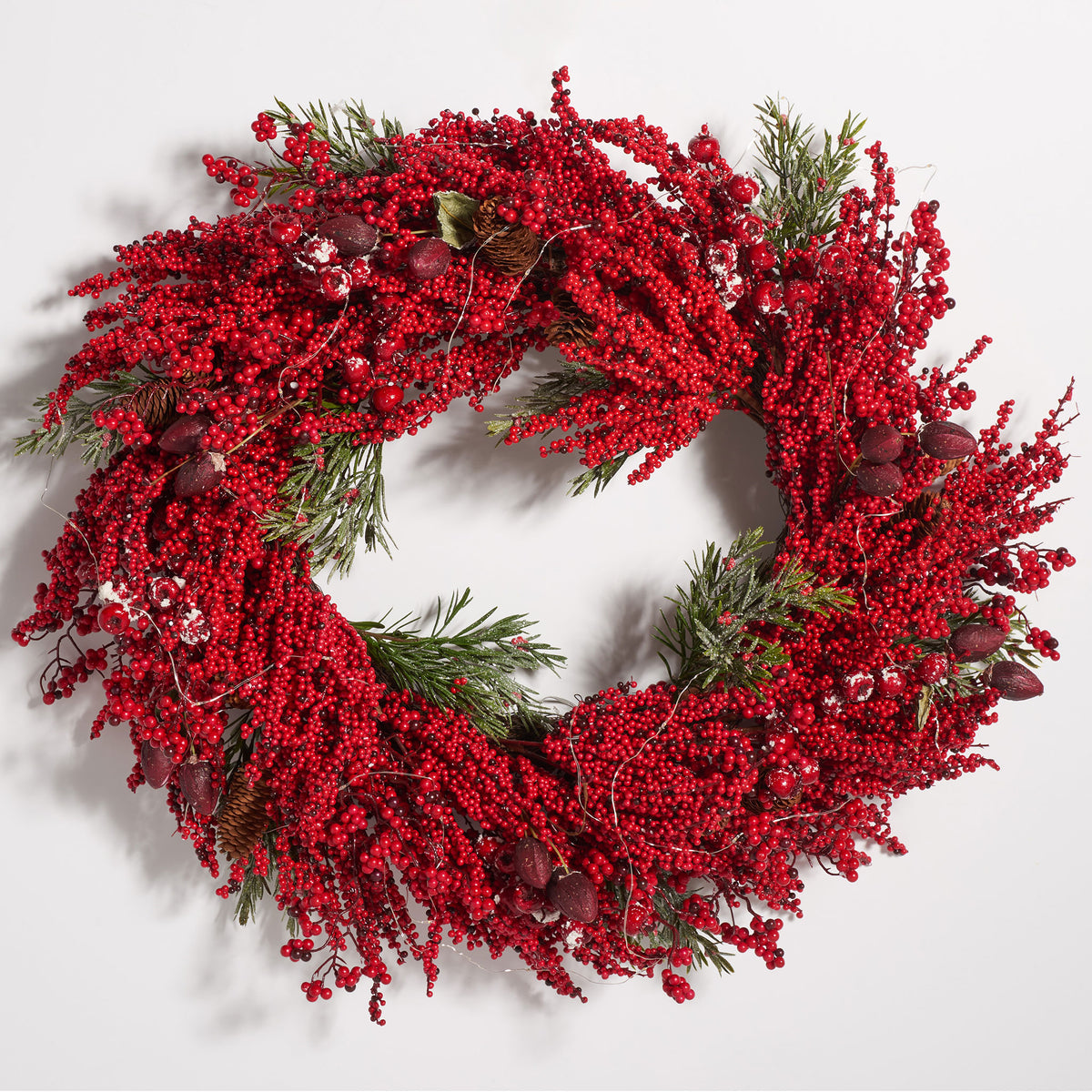 Lush crimson berries encircle green pine foliage and decorative accents. || FXP1093A || front_studio