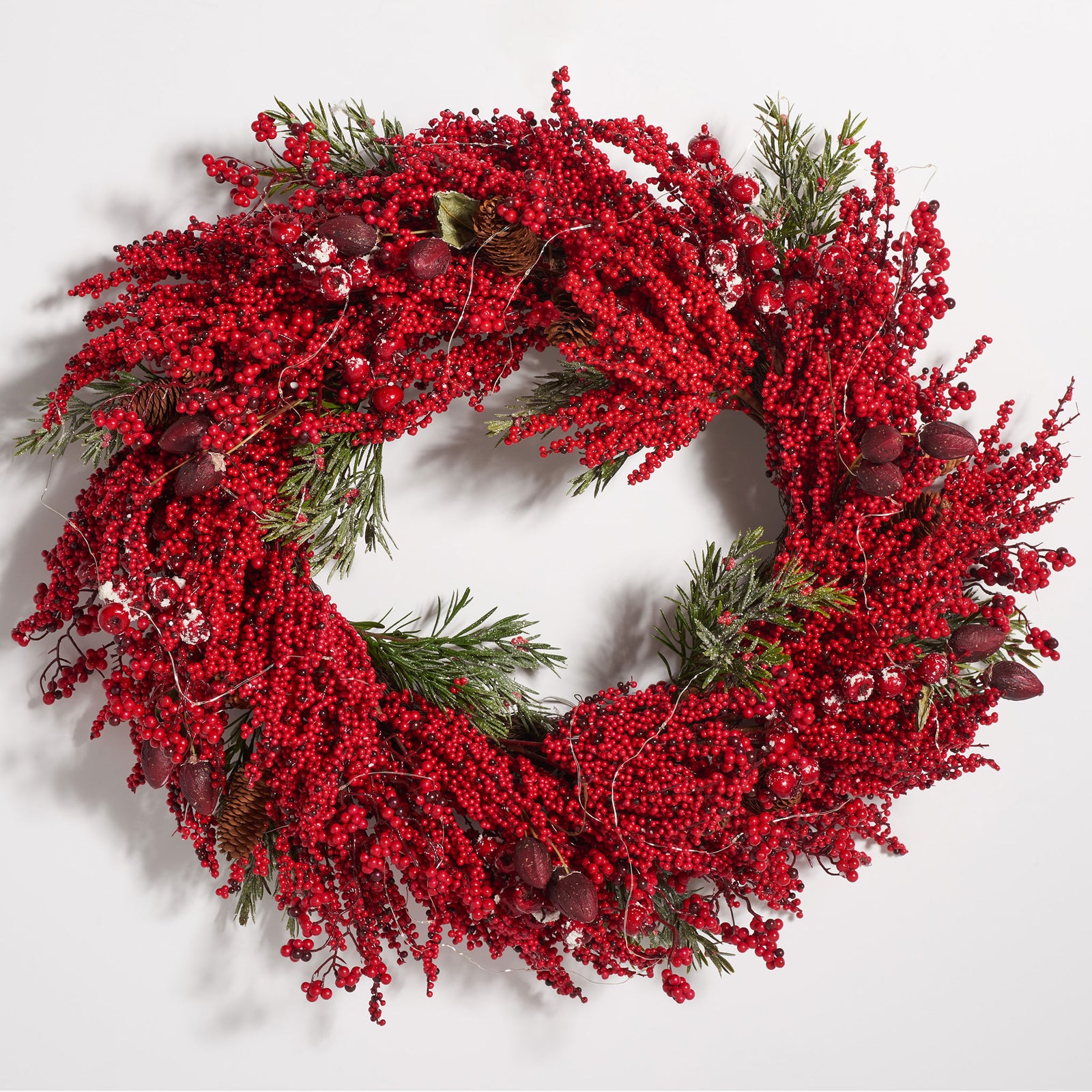 Lush crimson berries encircle green pine foliage and decorative accents. || FXP1093A || front_studio