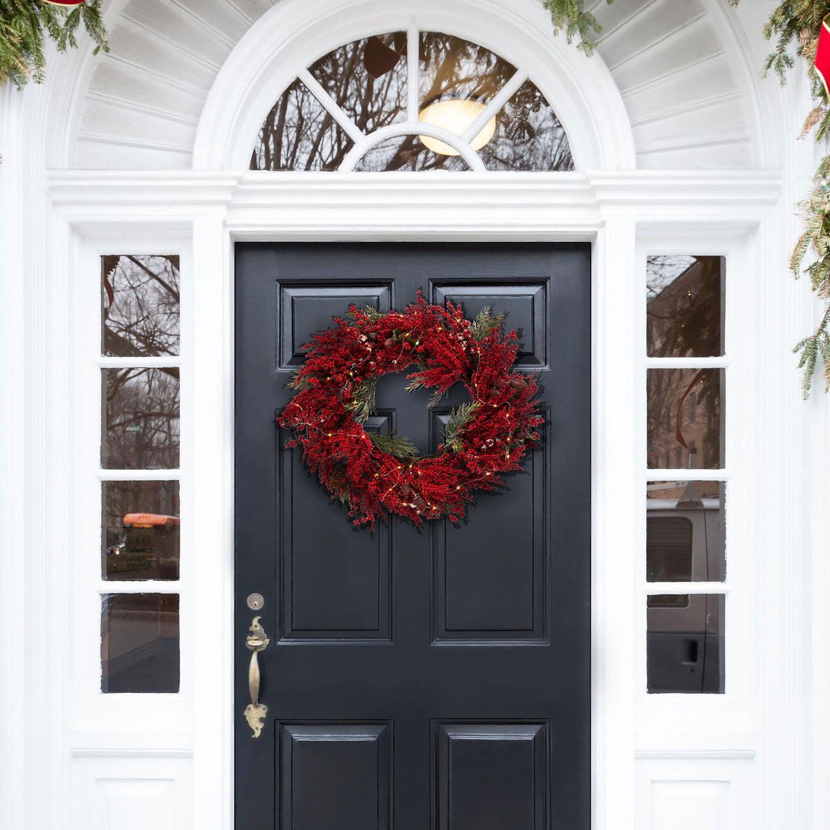 A richly berried wreath adds bold Christmas color to a dark entry door. || FXP1093A || front_room