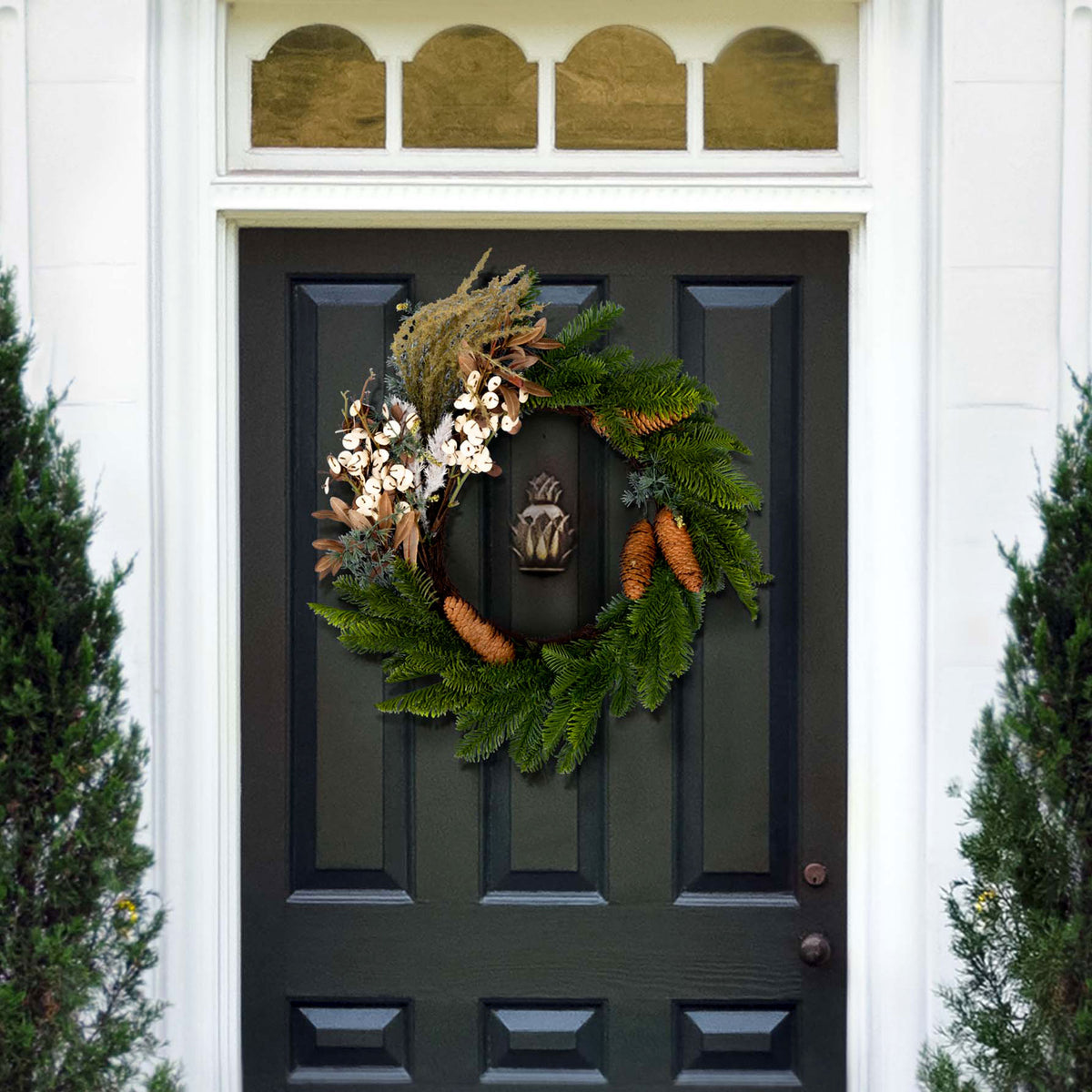 Pine branches and pale blossoms make a natural winter door accent.