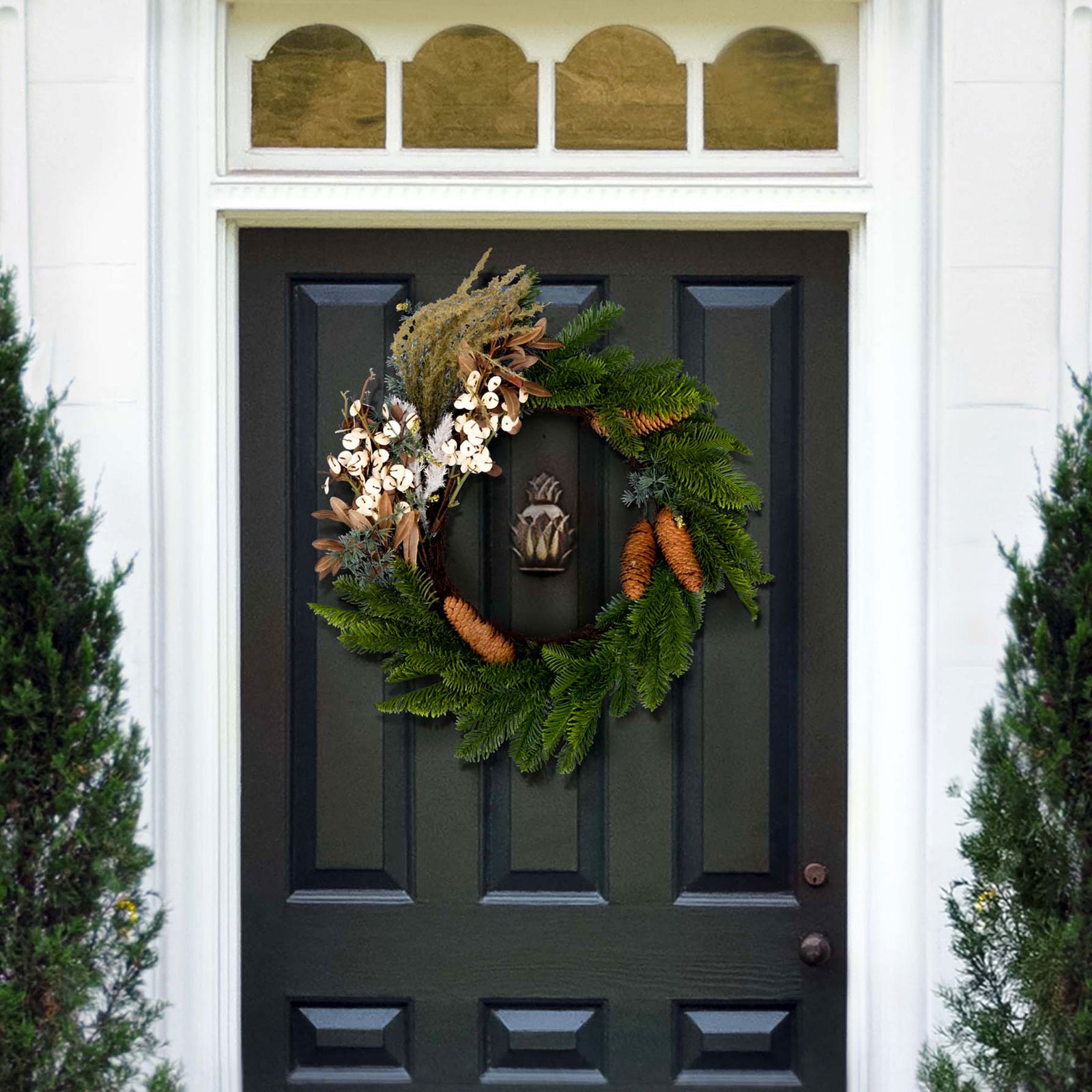 Pine branches and pale blossoms make a natural winter door accent. || FXP1095A || front_room