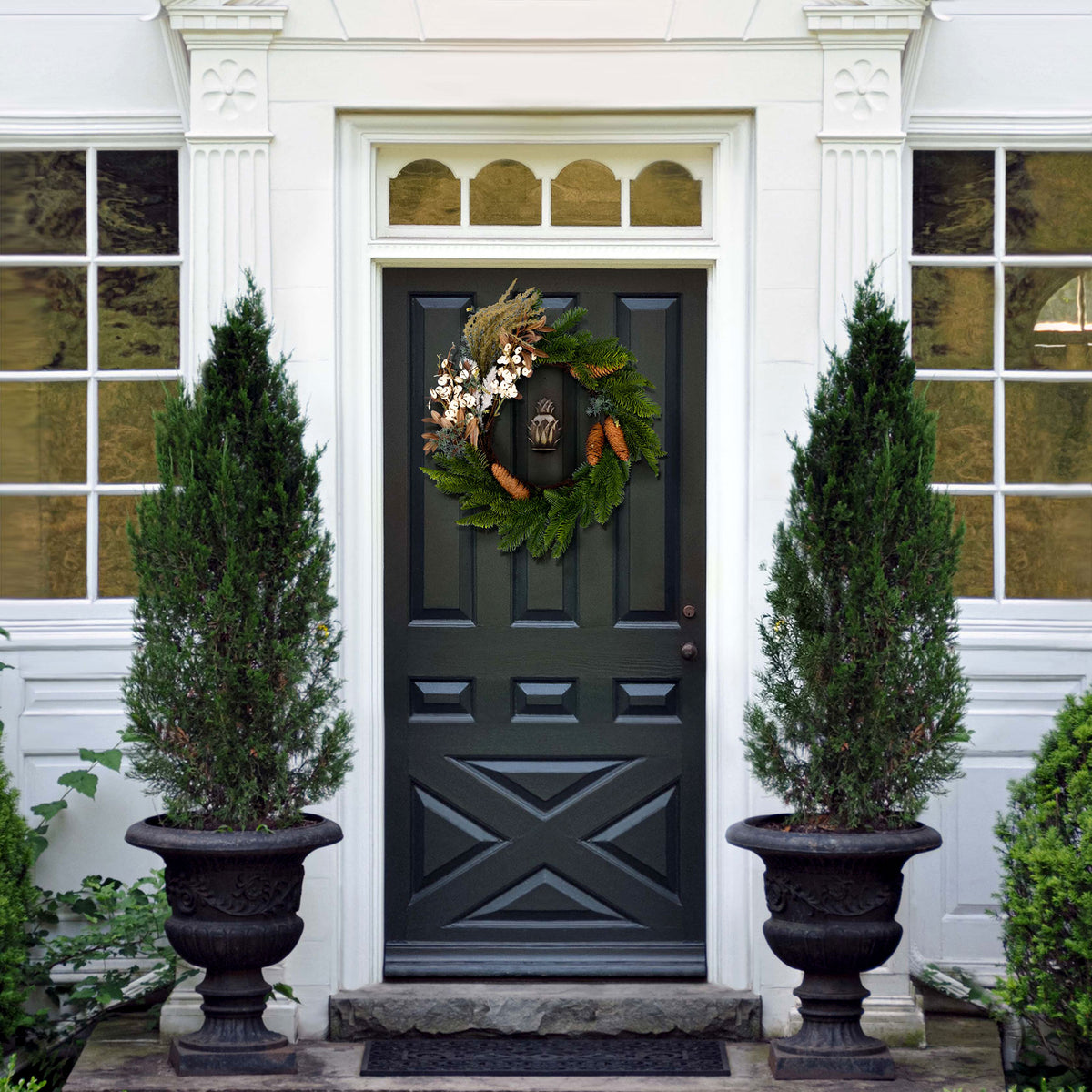 An evergreen wreath lends understated holiday charm to the entryway. || FXP1095A || front_room