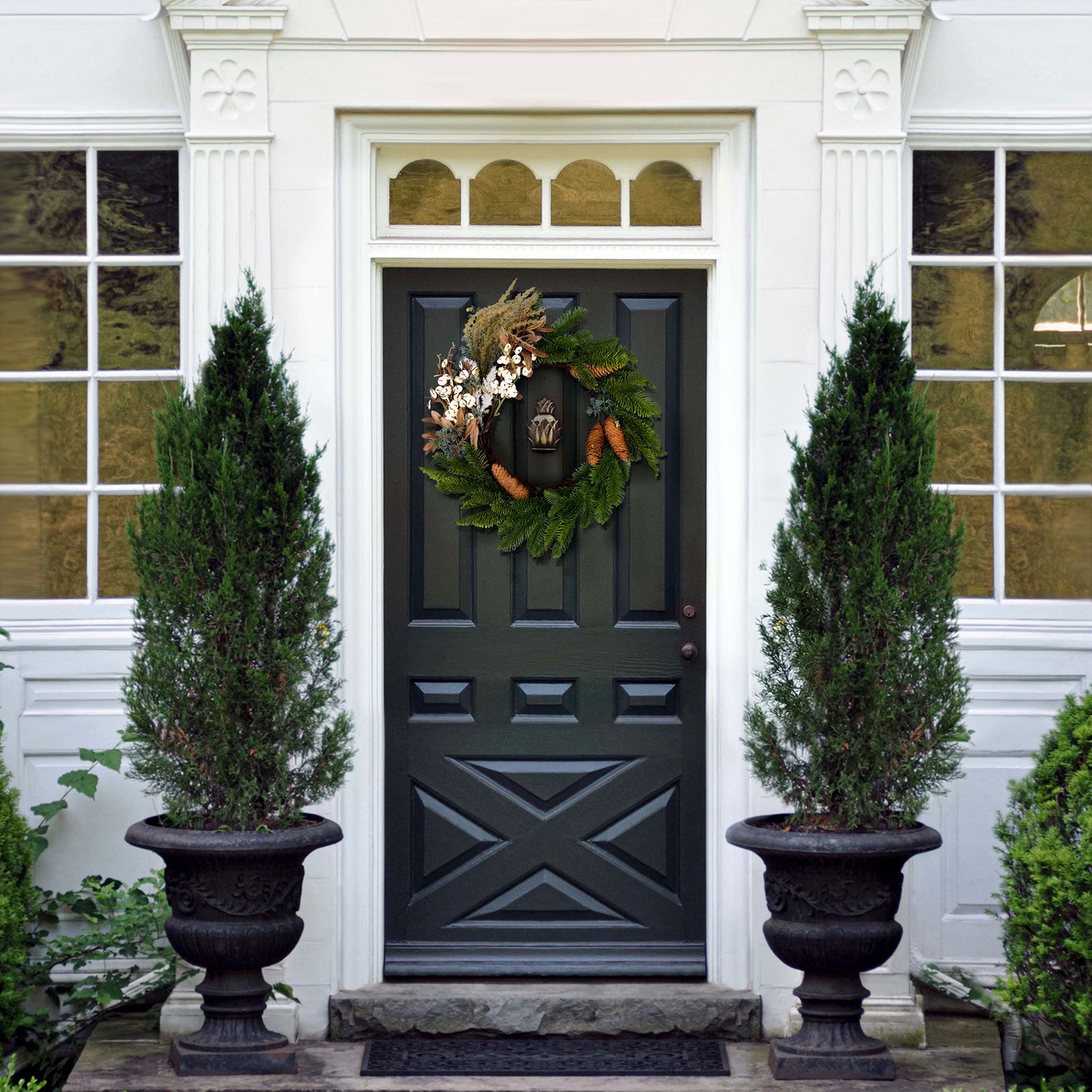 An evergreen wreath lends understated holiday charm to the entryway. || FXP1095A || front_room
