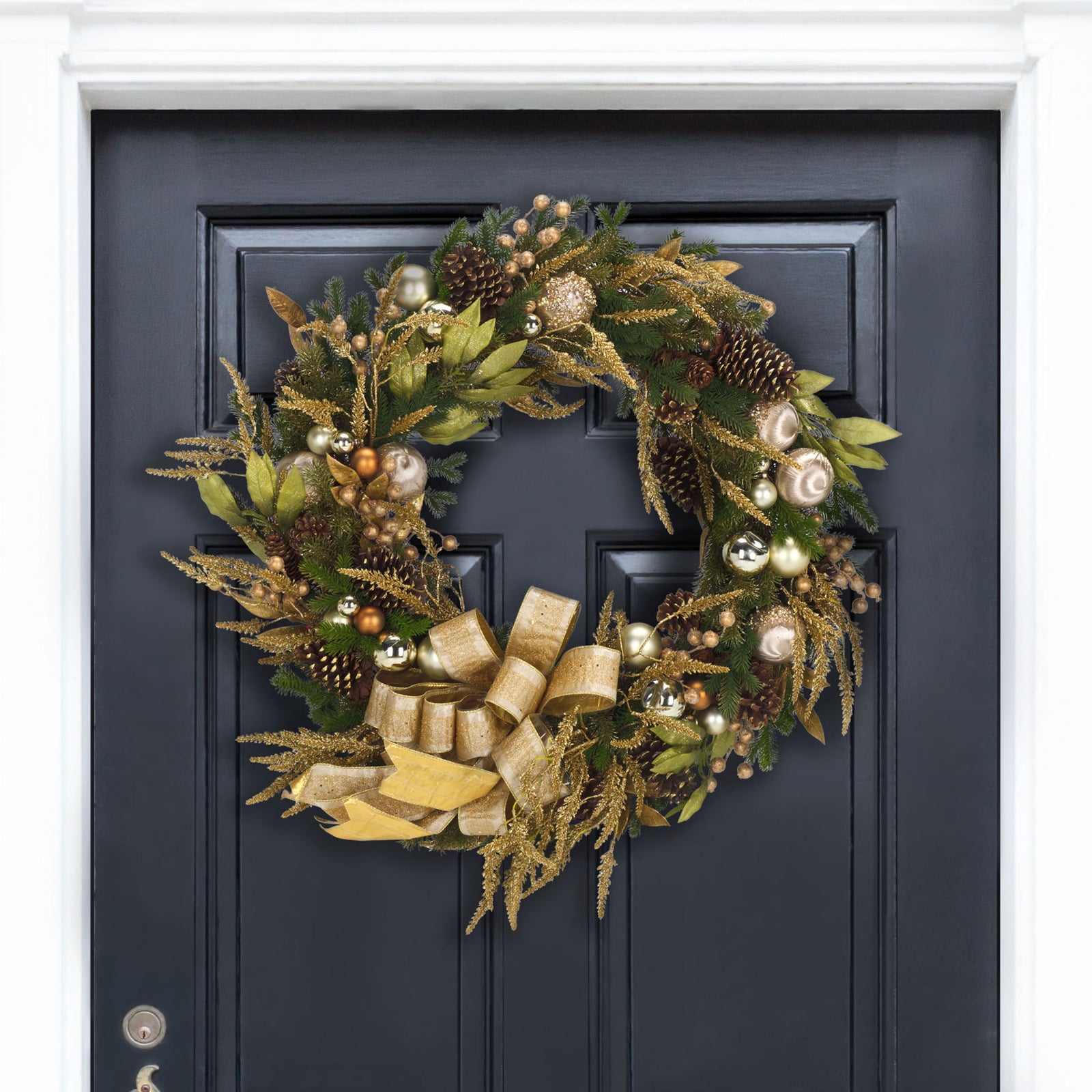 A sweeping gold bow and gleaming ornaments bring holiday warmth to a dark entry door || FXP1097A || front_room