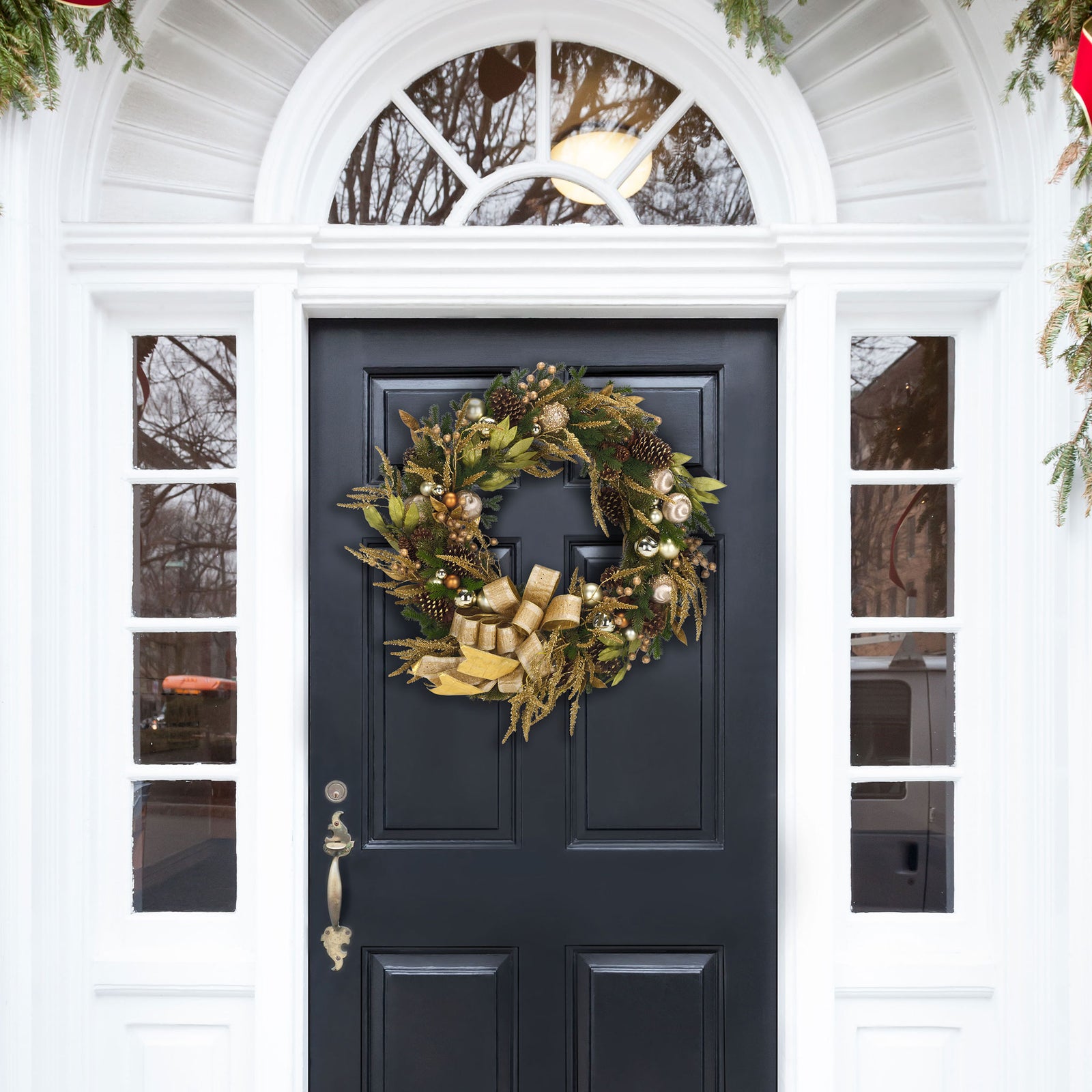 Gold ribbon and lush evergreen branches turn an entry door into a welcoming holiday display || FXP1097A || front_room