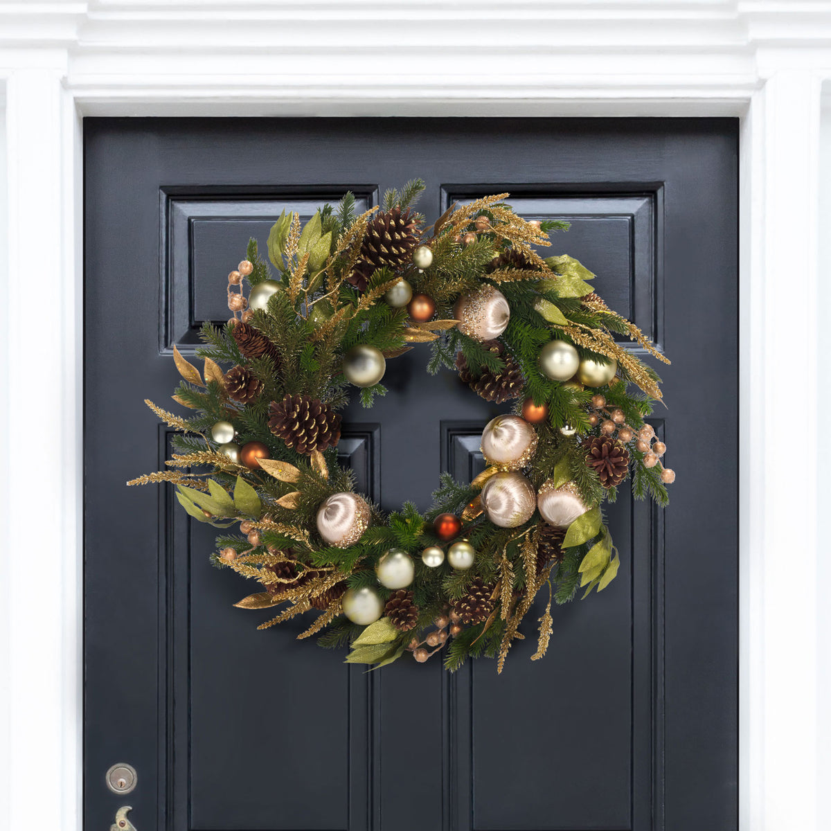 Champagne ornaments and gold foliage add festive sparkle to a dark entry door