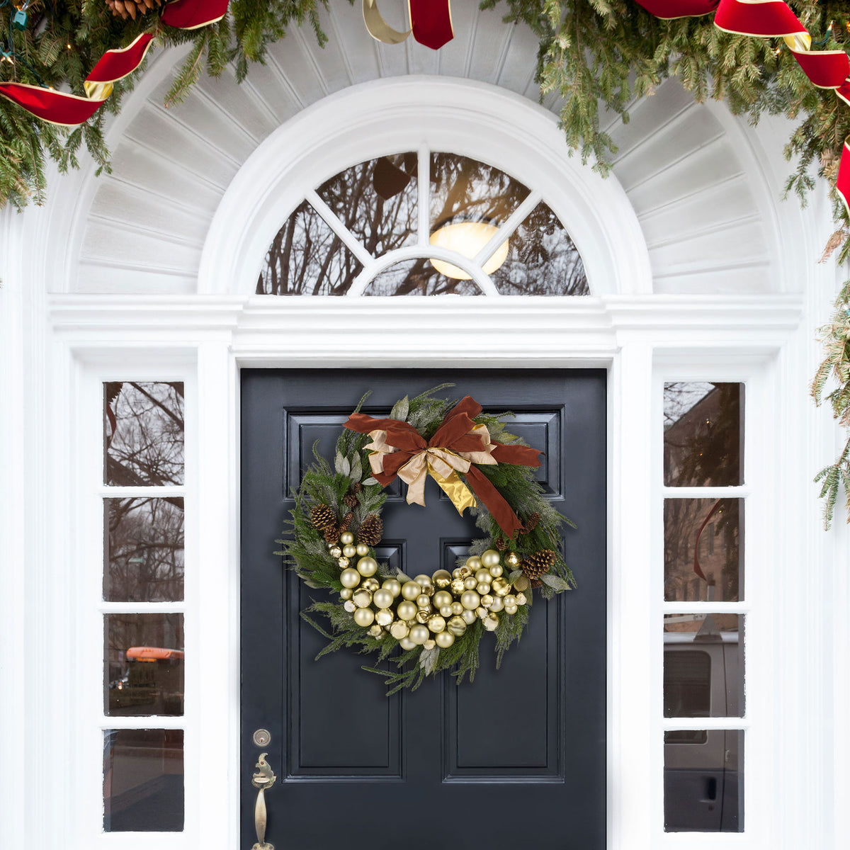 A lush holiday wreath welcomes visitors with shiny ornaments, pine cones, and a festive bow. || FXP1099A || front_room