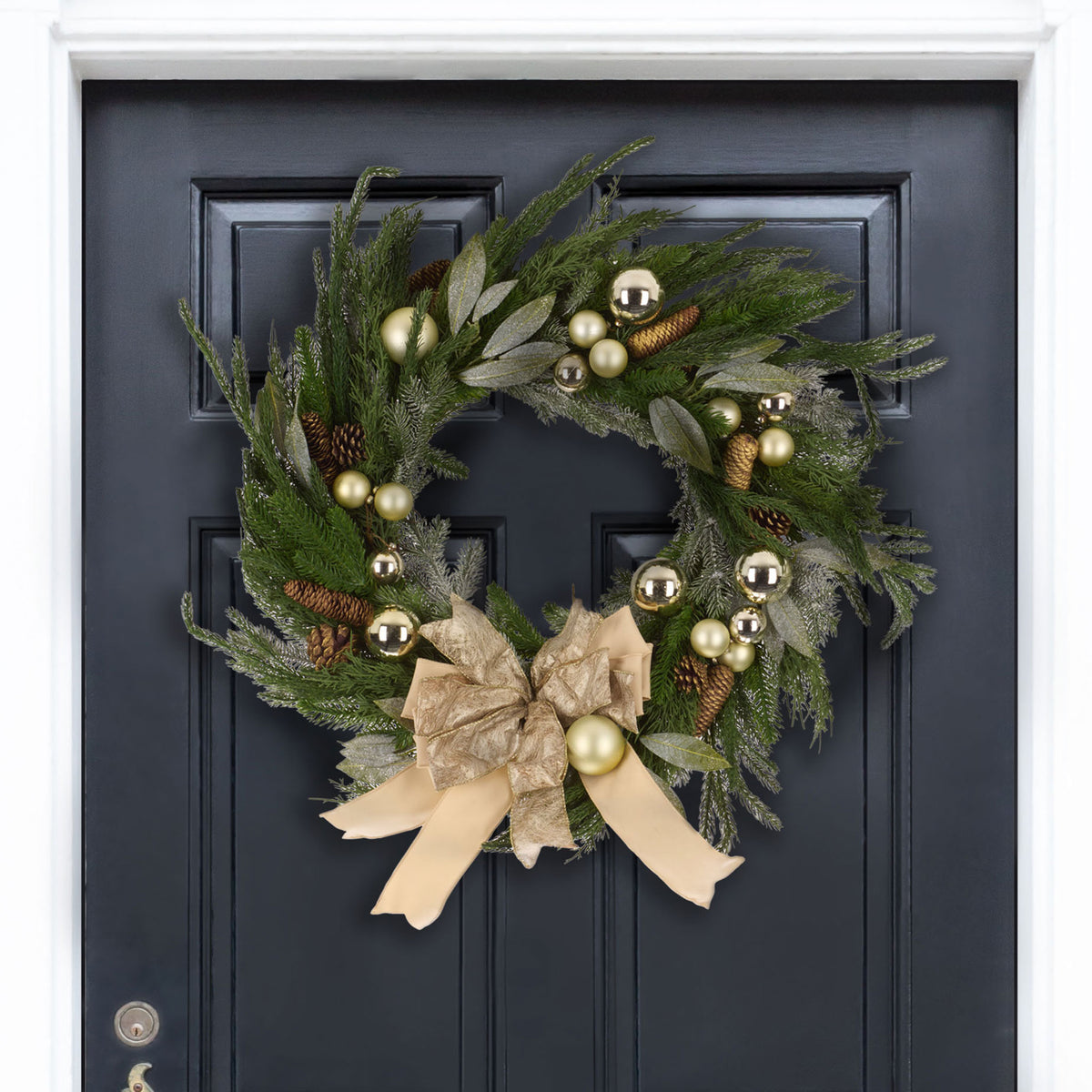 Golden baubles and silvery leaves frame a soft champagne bow amid lush evergreen branches. || FXP1100A || front_room