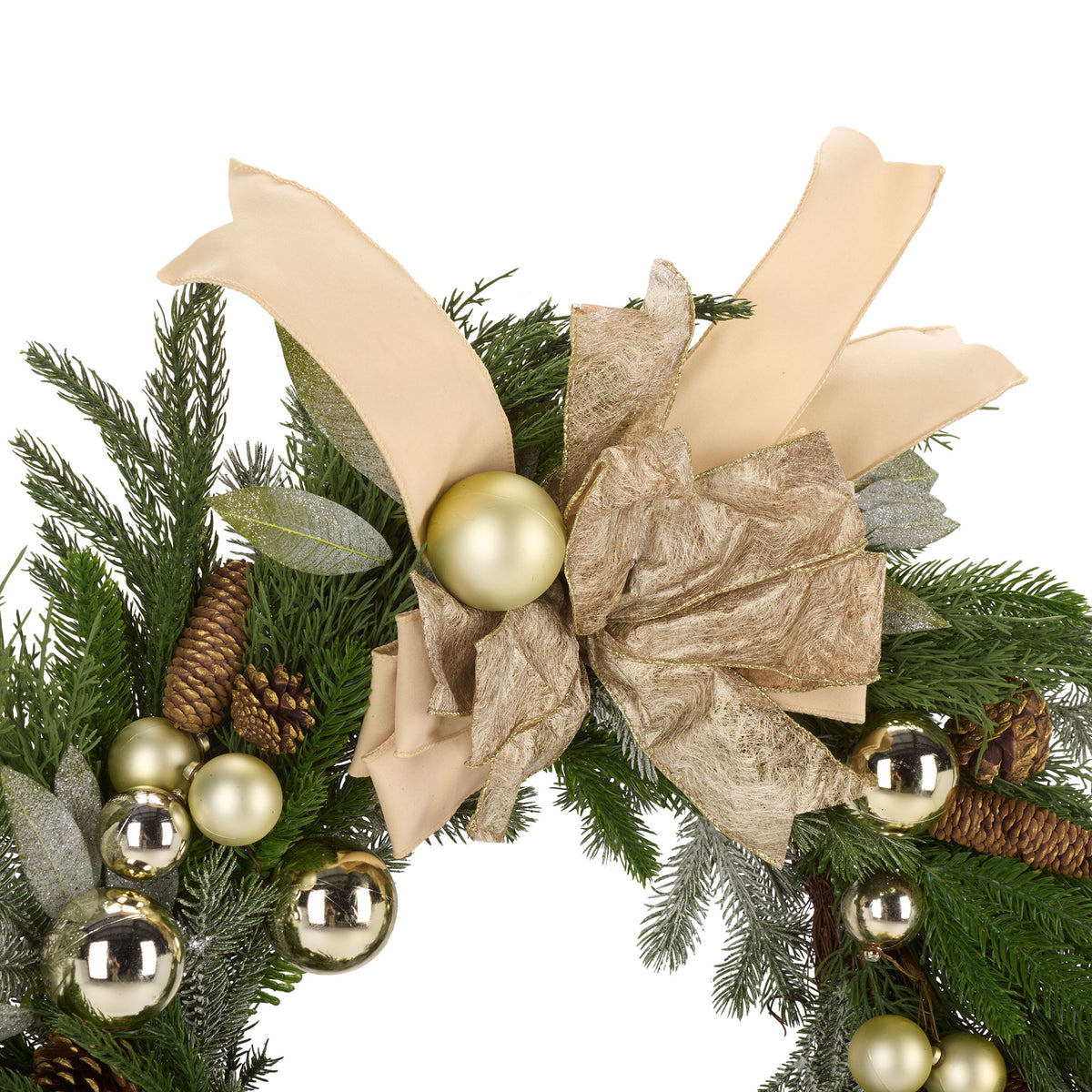 A shimmering gold bow and cream ribbons mingle with pine cones and metallic ornaments.
