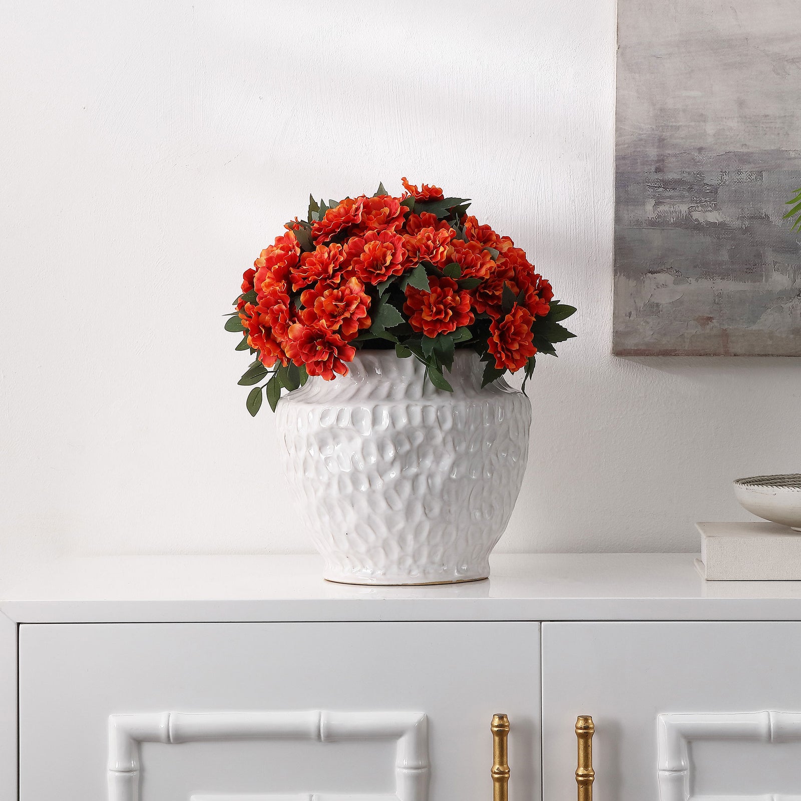 Vibrant marigolds brighten a white planter on a cabinet. || FXP2030A || front_room