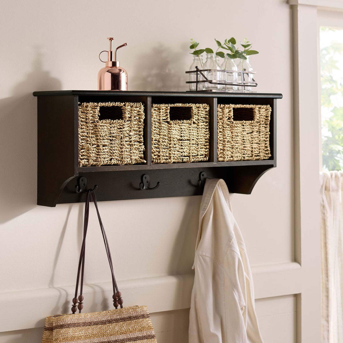 Dark chocolate wall storage keeps woven baskets, a handbag and outerwear neatly in place || HAC5700D || front_angle_room