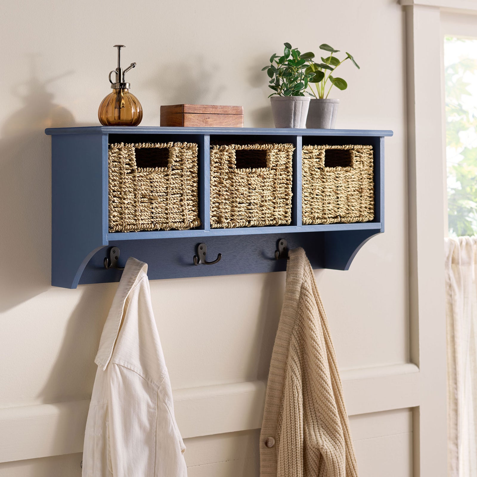A blue wall-mounted rack keeps outerwear within reach while woven baskets conceal clutter || HAC5700F || front_angle_room